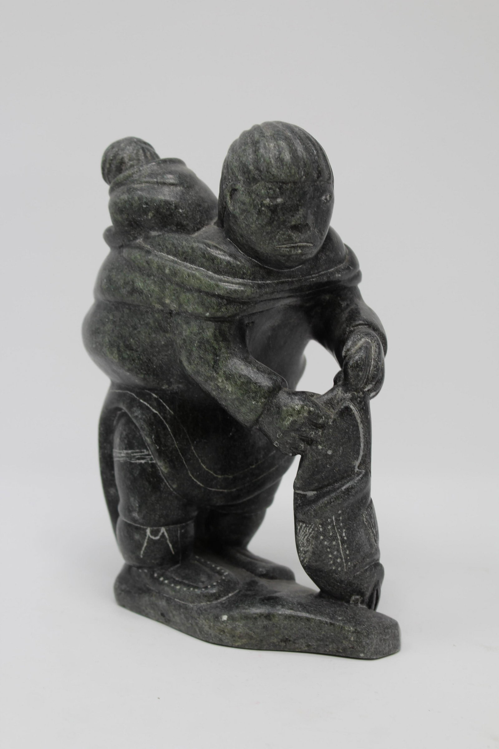 Signed, Inuit Carved Eskimo Figures w/ Fish: Signed, Inuit Carved Eskimo Figures w/ Fish. Signed on base. Height: 7 in. Approx. Weight: 5 lbs.