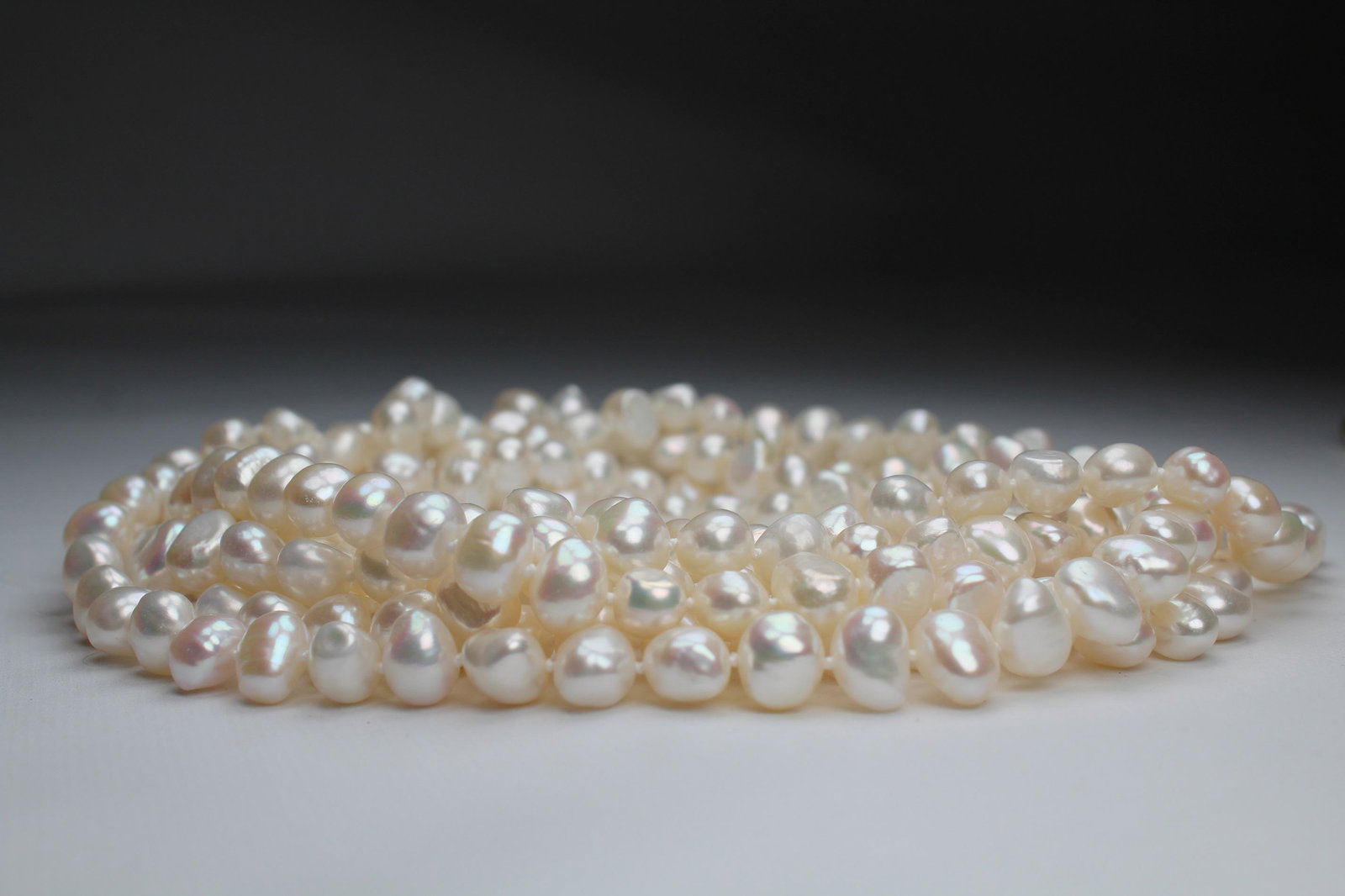 Unusual 100 inch Strand of White Freshwater Pearls: 100 inch Strand of White Freshwater Pearls. This strand of pearls ranges from 9-10 mm in size. - All silver, gold and/or jewelry lots or invoices containing said lots MUST be paid for via wire transfe
