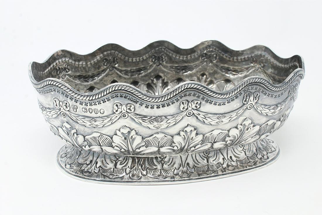 Antique Sterling Silver Bowl: Antique Sterling Silver Bowl. With floral motif surrounding exterior. Hallmarked near rim. Weight: 232 g / 8.2 oz. Dimensions: 2.5 x 6.75 x 4.25 in.