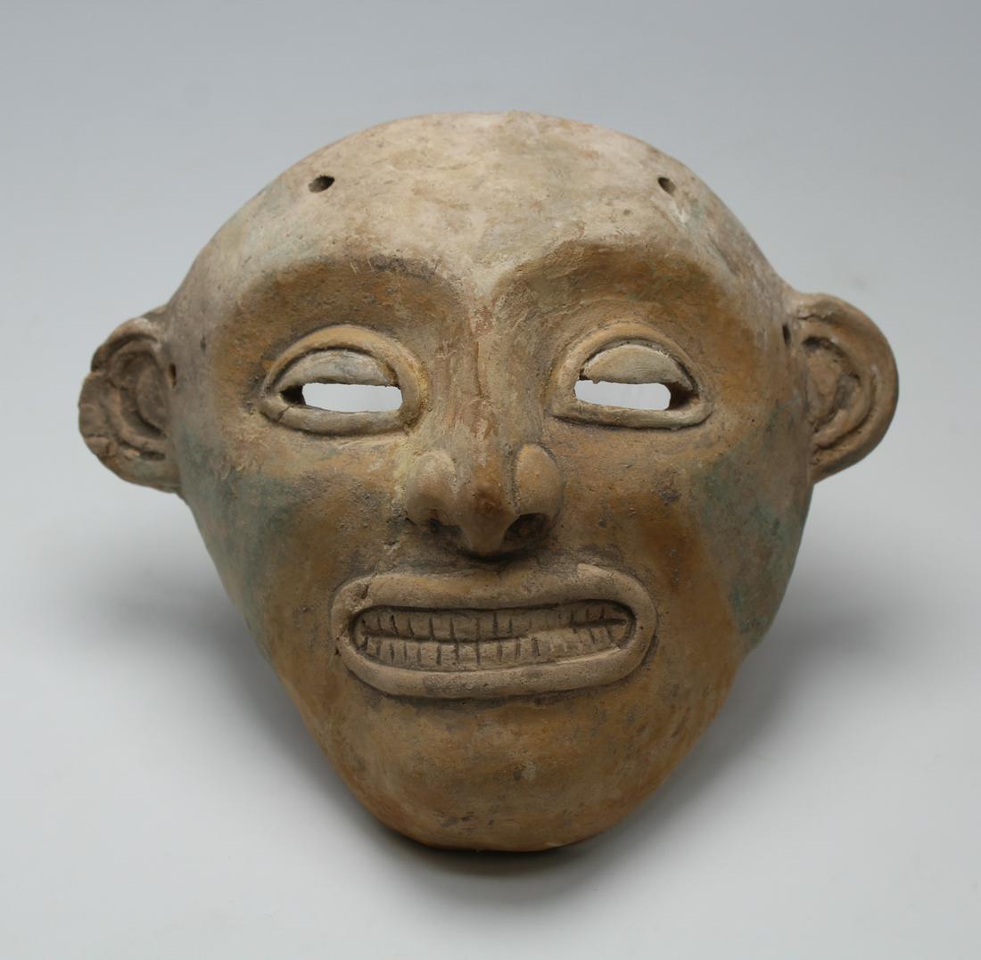 Jamacoaque Maskette - Ecuador 300 BC - 400 AD: An excellent Jamacoaque maskette from Ecuador, ca. 300 BC - 400 AD. This beautiful Chone type is 5" high, 5-3/4" wide and depicts an individual with crisply incised teeth visible in the open mouth. Th