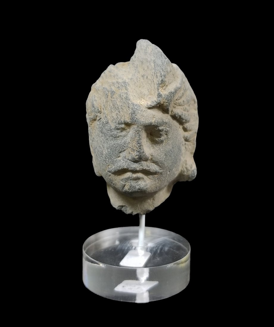 Gandharan Stonehead, Indus Valley, 3rd-4th C. AD: An excellent Gandharan stone head from the Indus Valley, ca. 3rd - 4th Century AD. This choice example is 2.25 in. high, is carved from the typical gray schist and depicts a nicely detailed man adorne