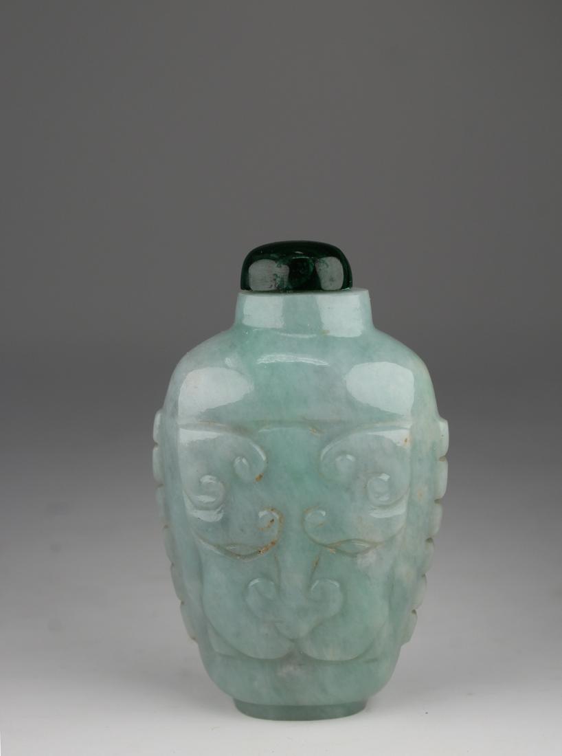 Carved Chinese Jadeite Snuff Bottle: Carved Chinese Jadeite Snuff Bottle. 19th/20th century. Well carved in low relief on each side with a pair of stylized, confronting dragons and enclosing a shou(longevity) character, the narrow sides 