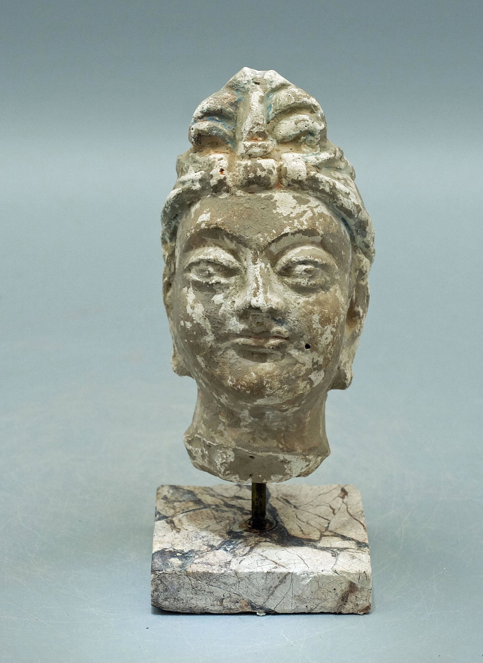 Gandharan Stucco Head - Indus Valley: A lovely Gandharan stucco head from the Indus Valley, ca. 4th - 5th Century AD. This superbly detailed sculpture is 3-5/8 inches high, is masterfully carved from stucco and depicts a bodhisattva. He i