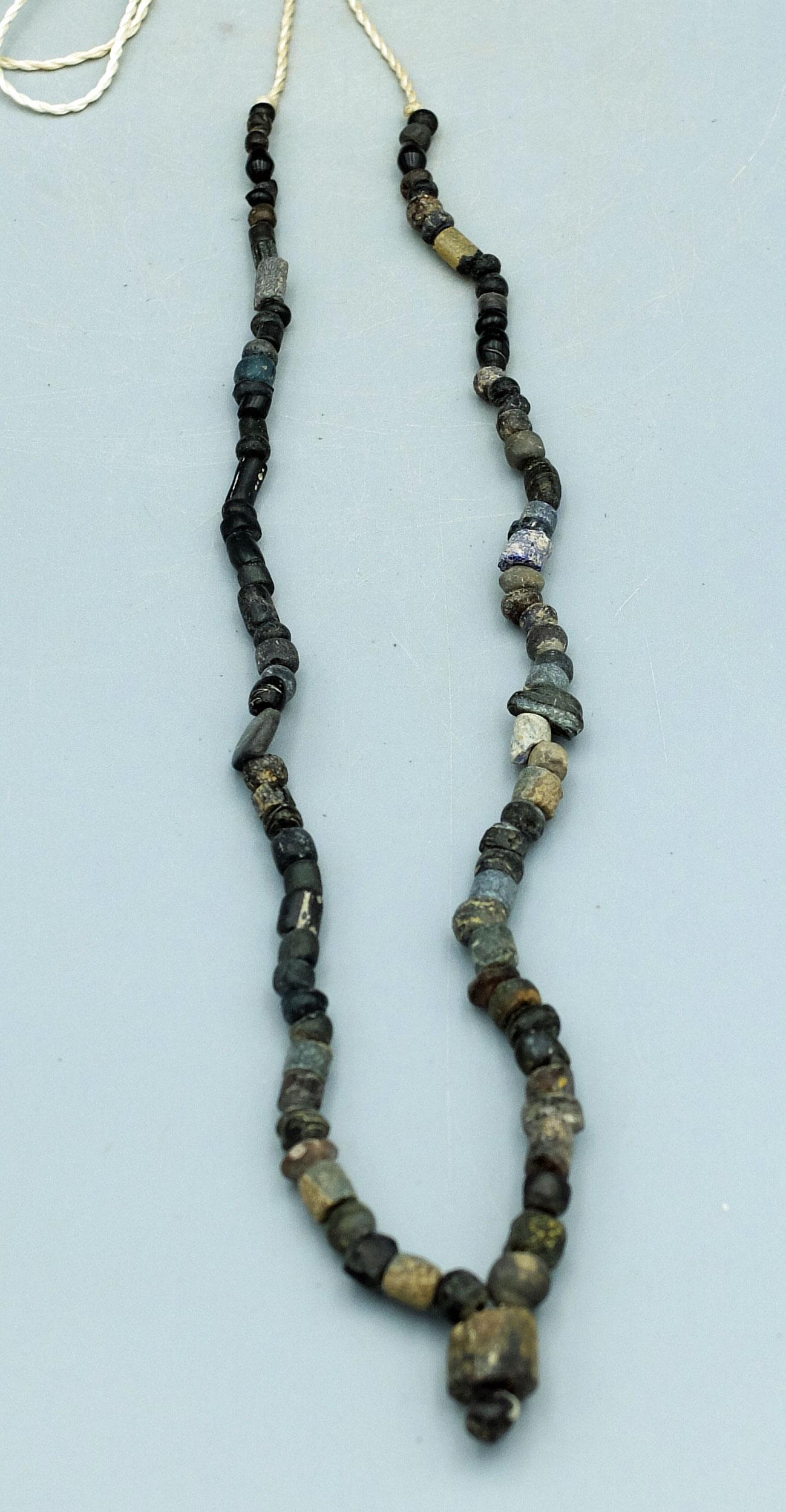 Strand of Roman Beads, ca. 2nd - 4th C. AD: A strand of Roman beads, ca. 2nd - 4th Century AD. It is 16 inches long and consists of a variety of stone and glass beads. (B185A)