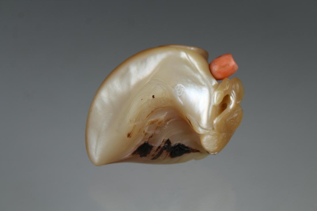 Unusual Mother of Pearl Snuff, Coral Stopper: Rare and unusual carved mother of pearl snuff bottle with a coral stopper. Carved with a mountainous landscape and animal figures throughout. Provenance: Private Downtown Sarasota collection. Height: 