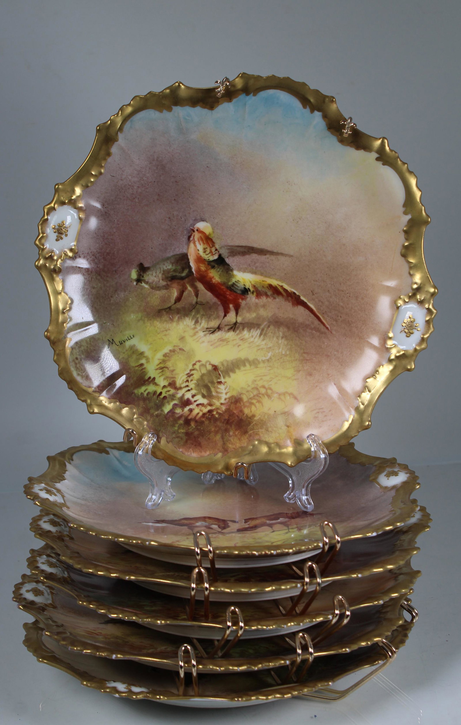 (6) Signed French Limoges Gilt Porcelain Dishes: (6) Signed French Limoges Gilt Porcelain Dishes. Each having hand painted birds, signed "Muville" in lower portion. Marked on backside. Diameter: 9.25 in.