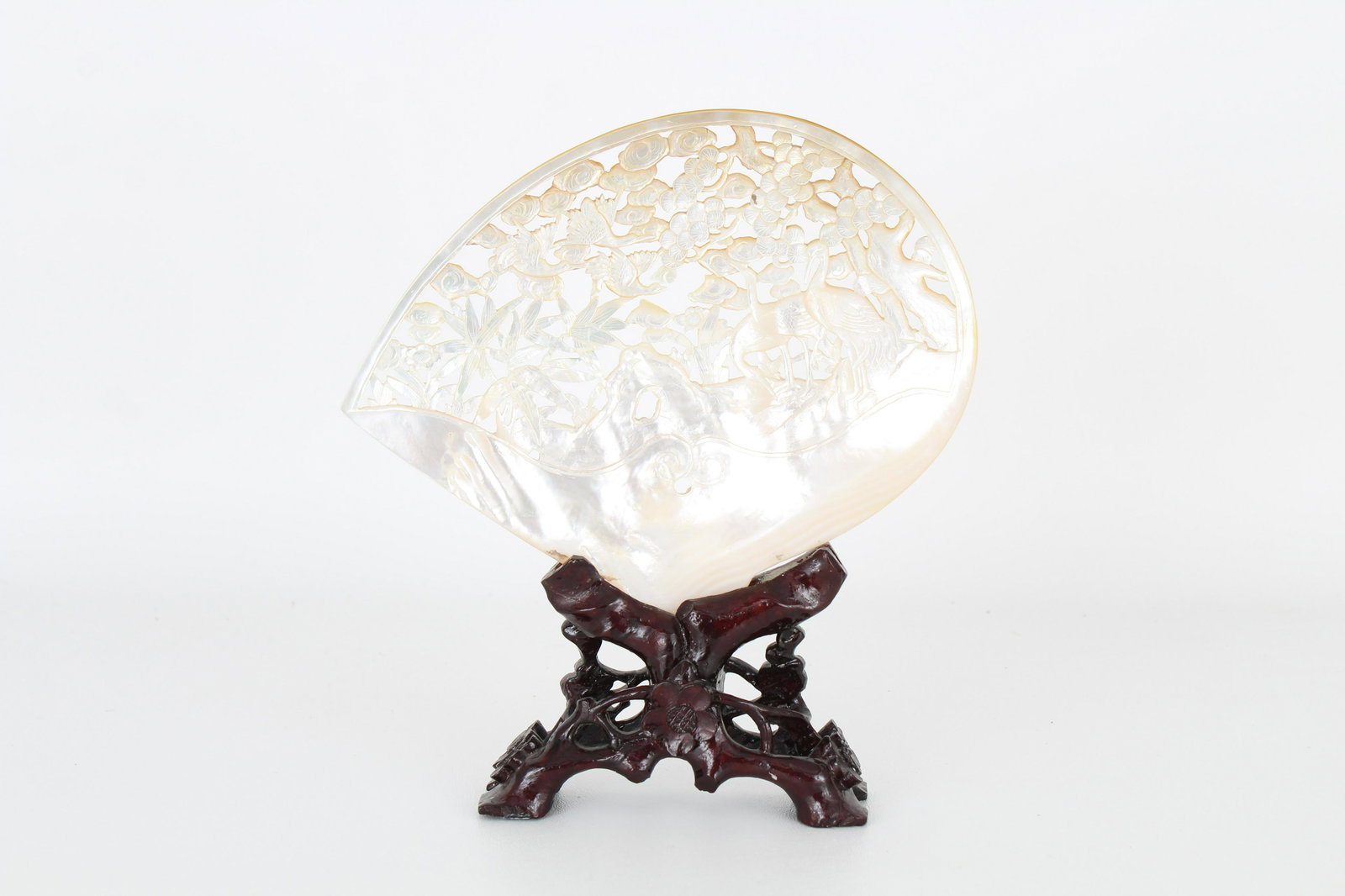 Chinese Mother of Pearl Carving on Wooden Stand: Chinese Mother of Pearl Carving on Carved Wooden Stand. Carving depicting cranes amongst trees. Height: 8 in.