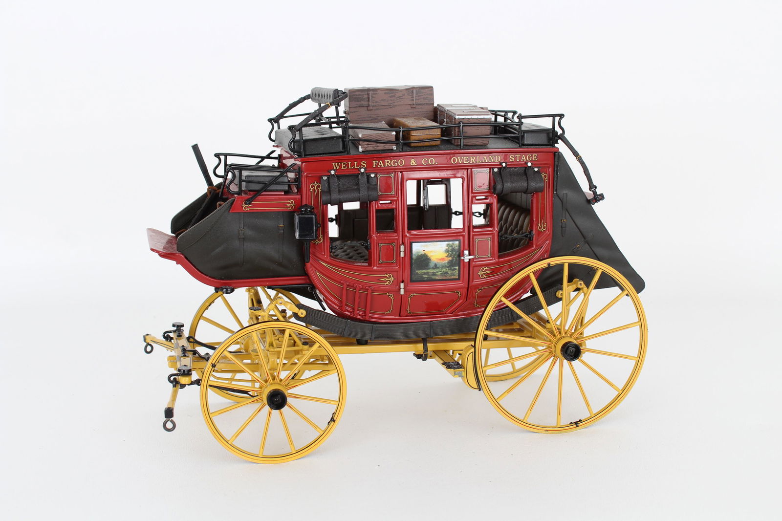 Wells Fargo & Co. Overland Stage Coach: Wells Fargo & Co. Overland Stage Coach. Hand Painted on each side. Luggage resting atop the coach. Height: 6.5 in. Width: 9 in.