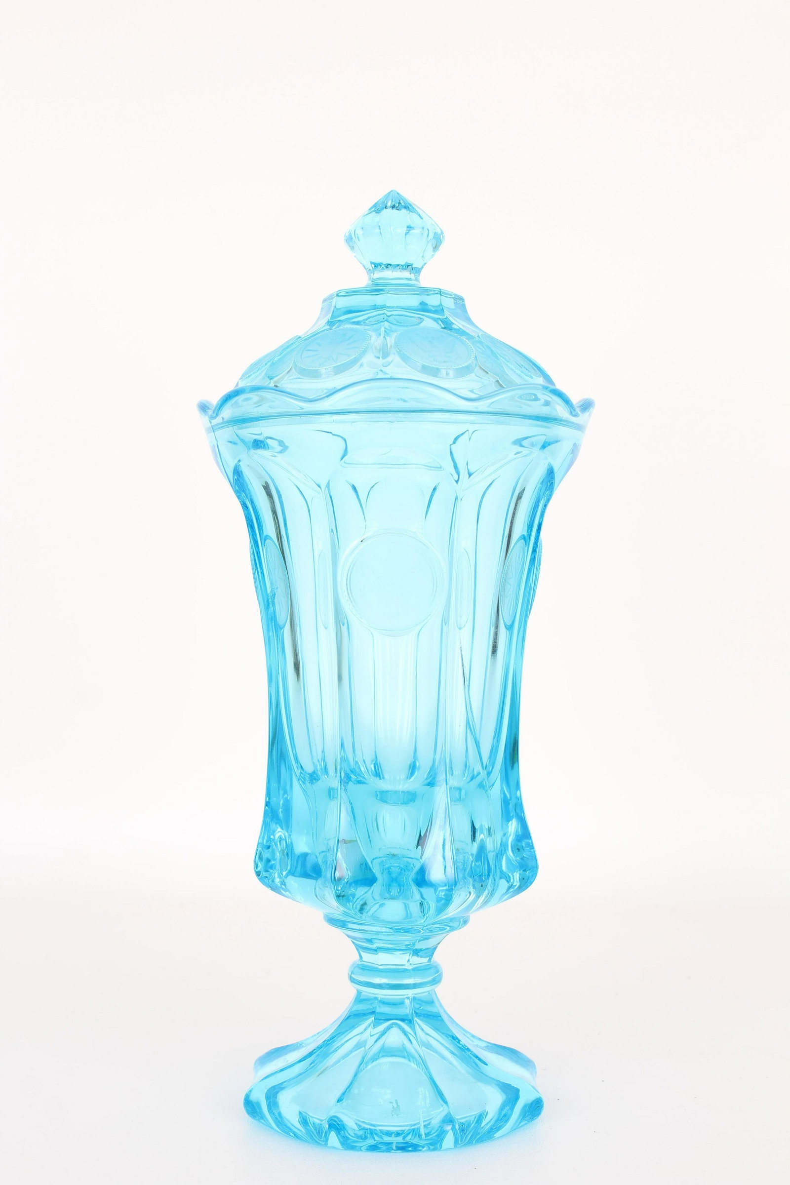 American Turquoise Glass Covered Jar (as is): American Turquoise Glass Covered Jar with American Eagle Emblems throughout exterior. Having hairline cracks. Overall Height: 12 in.