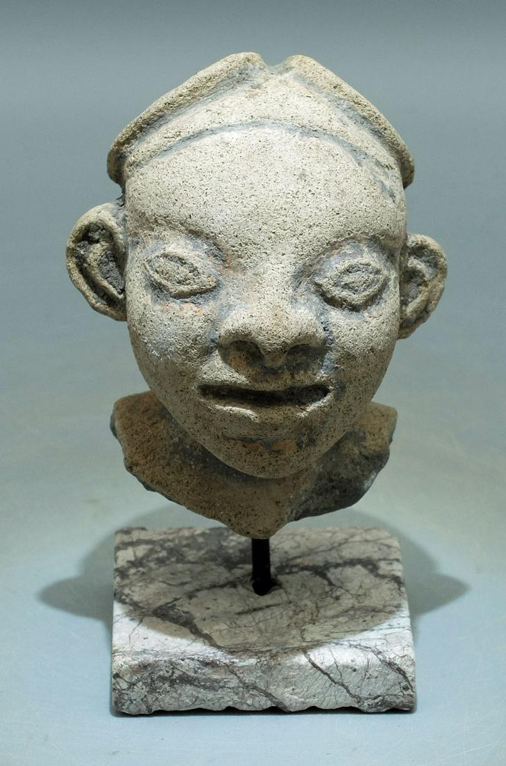 LaTolita Head - Ecuador, ca. 300 BC - 600 AD: A choice LaTolita head from Ecuador, ca. 300 BC - 600 AD. It is 3 in high and was found on a beach at the mouth of the Rio Santiago. It portrays a man with prominent ears wearing an unusual headdress.