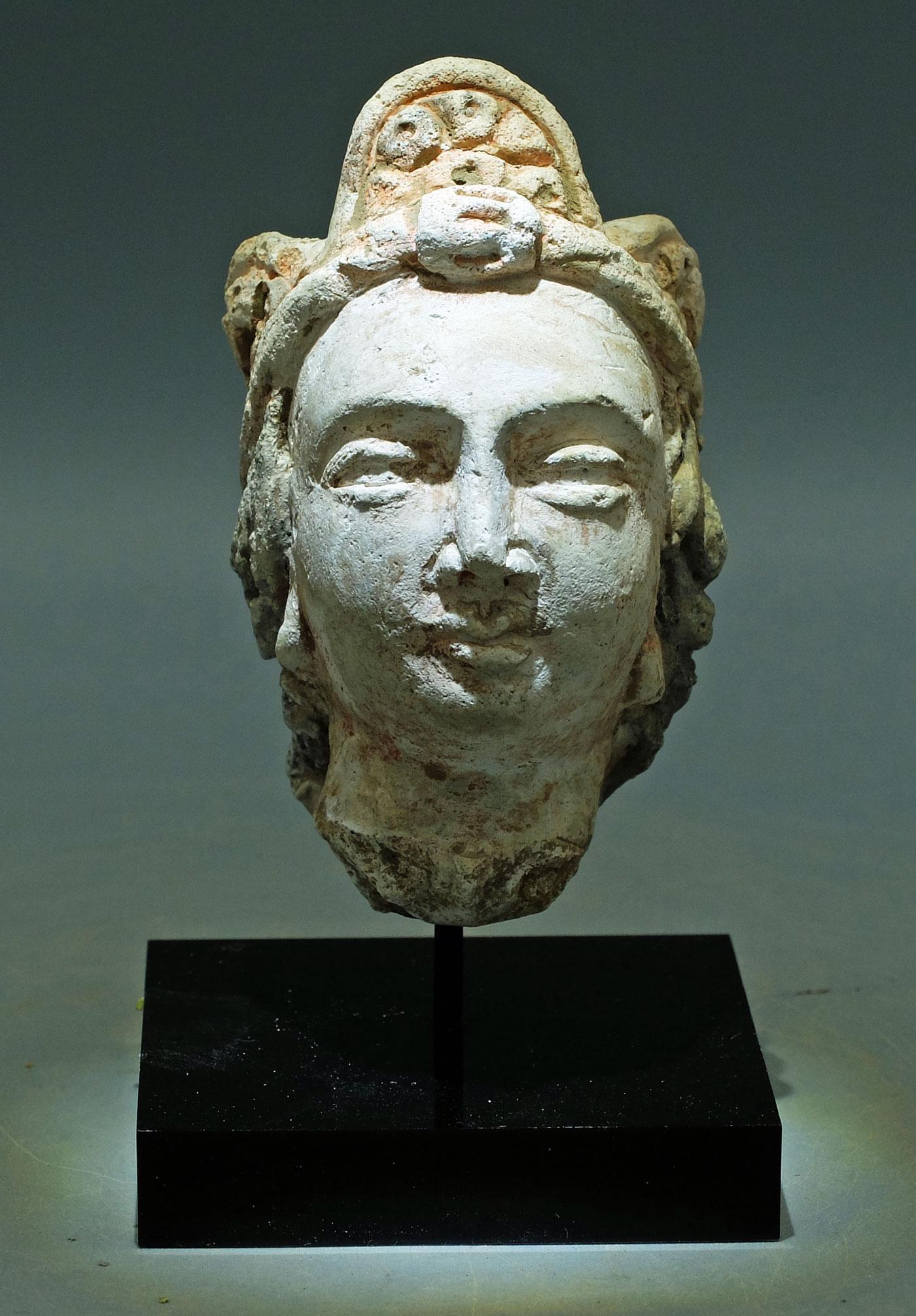 Gandharan Stucco Head - Indus Valley: A choice Gandharan stucco head from the Indus Valley, ca. 4th - 5th Century AD. This superbly detailed sculpture is 3-1/2 inches high, is beautifully carved from stucco and depicts a member of the wea