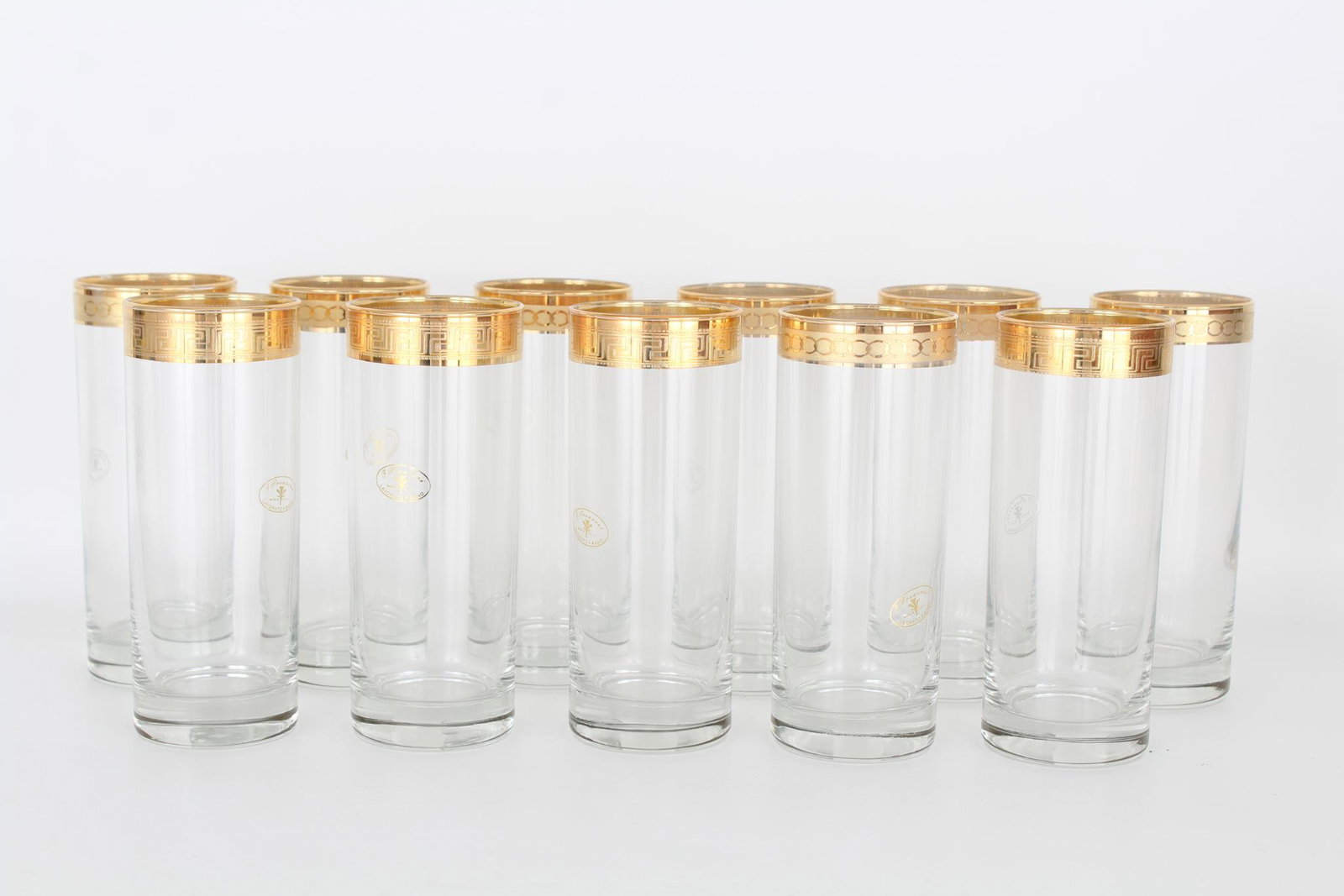 (11) L'Arte del decoro Artigianale Glass Cups: (11) L'Arte del decoro Artigianale Glass Cups. (7) cups having circle motif rim, (4) cups having repeating line motif rim. Heights: 6.5 in.