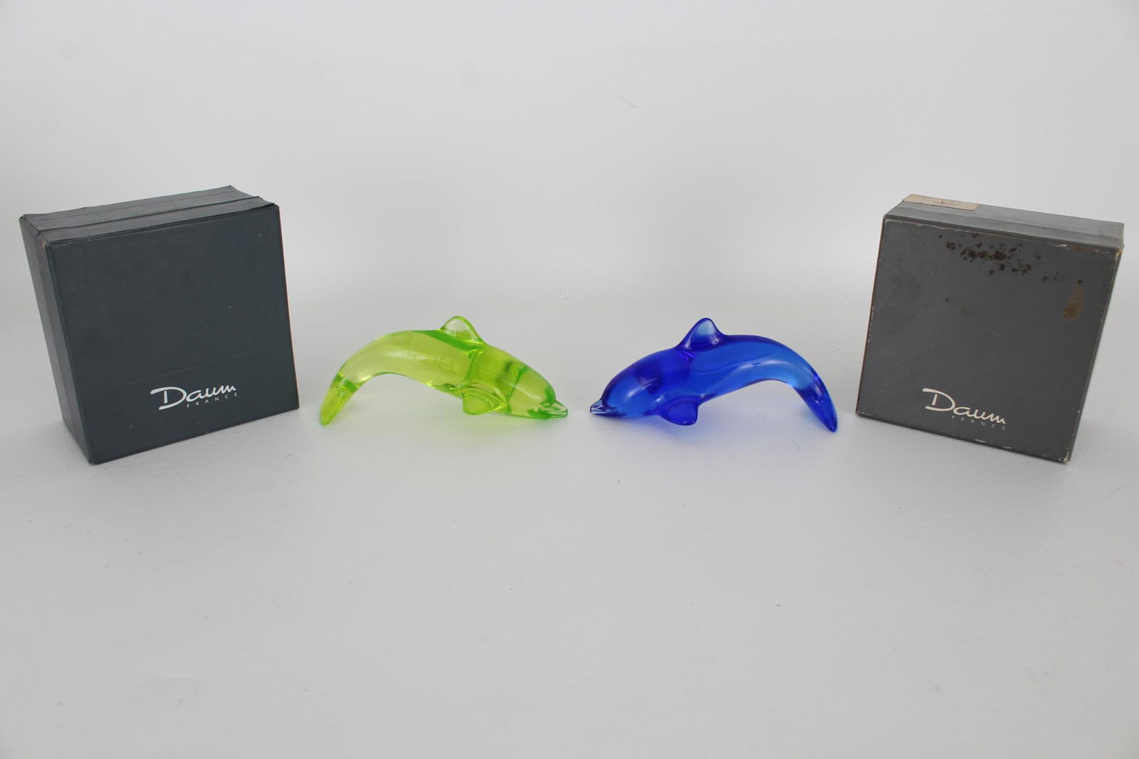 (2) Daum France Dolphin Figures in Original Box: (2) Daum France Dolphin Figures in Original Box. Signed near the side of each figure. Length: 4.5 in (each).