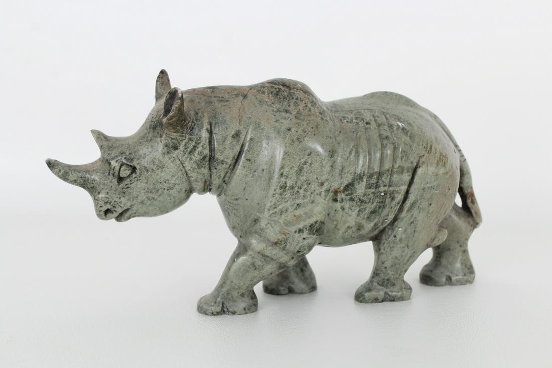 Carved Stone Rhinoceros: Vintage Carved Stone Rhinoceros. Appears to be unsigned. Dimensions: 3.5 x 7.75 in.