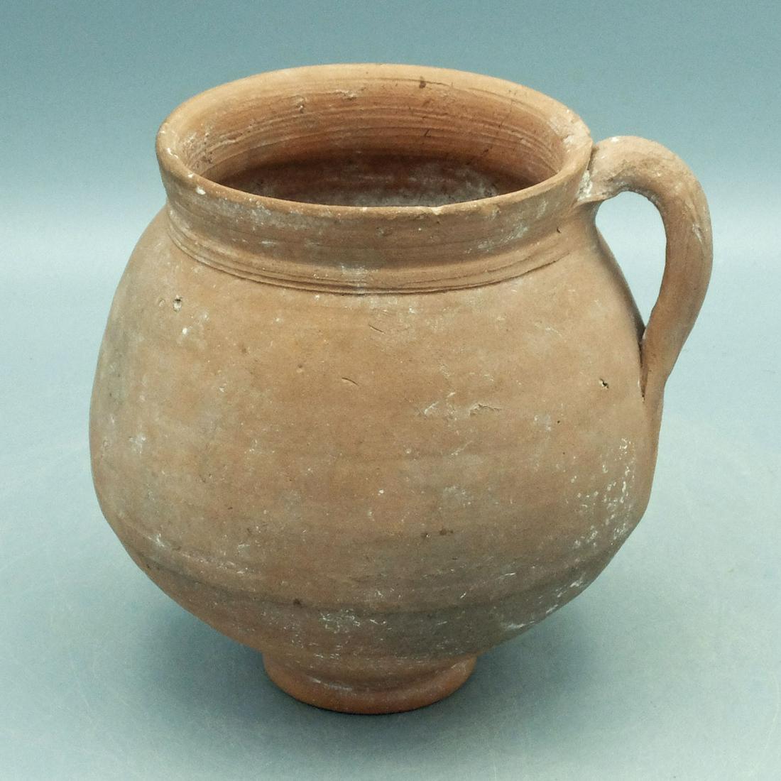 Hellenistic Round Bottomed Olpe, ca. 4th - 2nd C.: A fine Hellenistic round bottomed olpe, ca. 4th - 2nd Century BC. This lovely orange buff vessel is 4-3/4" high. 4-1/2" in diameter and stands on a concave ring base. It has a short neck with the flar