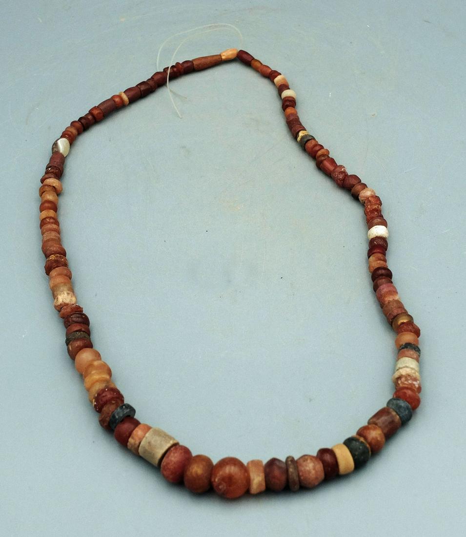 Tairona Bead Necklace - Colombia: A lovely Tairona necklace from Colombia, ca. 1000 - 1500 AD. It is 26" long and is comprised of primarily translucent carnelian beads. (B229)