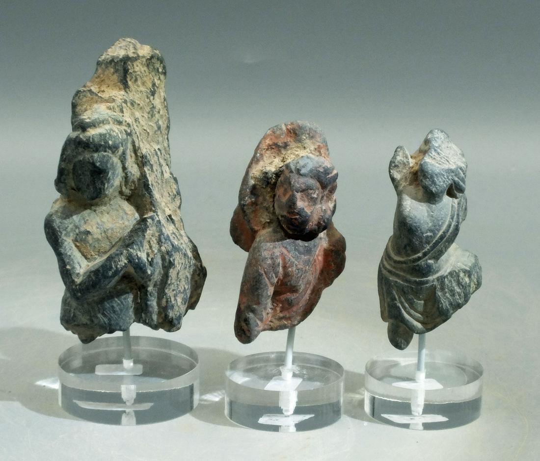 (3) Gandharan Stone Figures - Indus Valley: A trio of Gandharan stone figures from the Indus Valley, ca. 4th - 6th Century AD. They range from 2-1/4" to 3-3/4" high and are carved from the blue-gray schist typical of the area. The first depicts