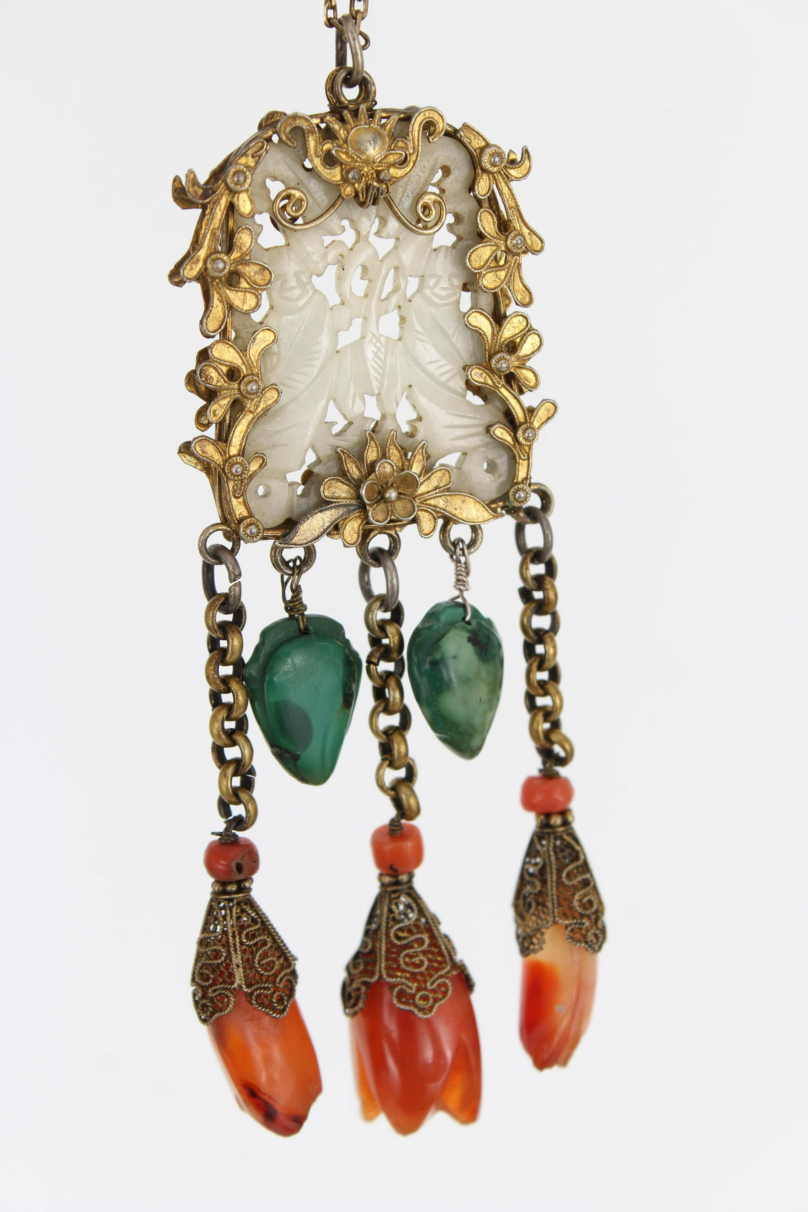 Jade, Carnelian & Malachite Jade Pendant: Jade, Carnelian & Malachite Jade Pendant. Pendant having carved jade plaque mounted inside intricately made floral border. Having malachite and carnelian carved flowers hanging from jade plaque. Size: