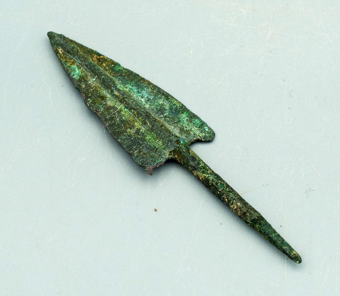 Bronze Arrowhead, Elamite Middle Period: A choice bronze arrowhead, Elamite Middle Period. 1200-800 BC. This excellent deltoid example is 3-1/2 in. long, has long, thin tapering tang and strong mineral deposits. Cf. Malloy "Weapons", # 93. C