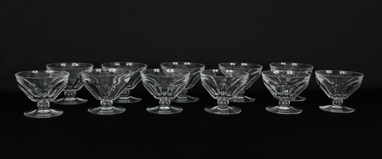 (11) Baccarat Crystal 'Talleyrand' Stemware: (11) Baccarat Crystal 'Talleyrand' Champagne / Sherbert Stemware. Size: 8 x 10.2 cm. (6) cups having minor chips to rim Each glass bears the etched stamp for Baccarat on the base which dates them betw