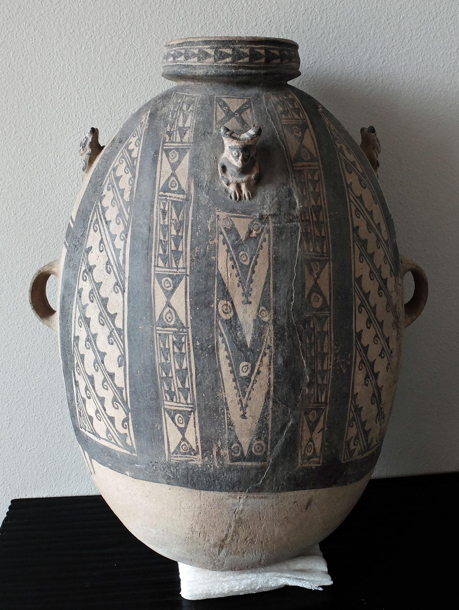Chancay Chicha Vessel - Peru, ca. 1100 - 1450 AD: An enormous Chancay chicha vessel from Peru, ca. 1100 - 1450 AD. This elaborately decorated storage vessel is 22 in. high, 16 in. wide and featured a trio of adorable figures emerging from the chamber