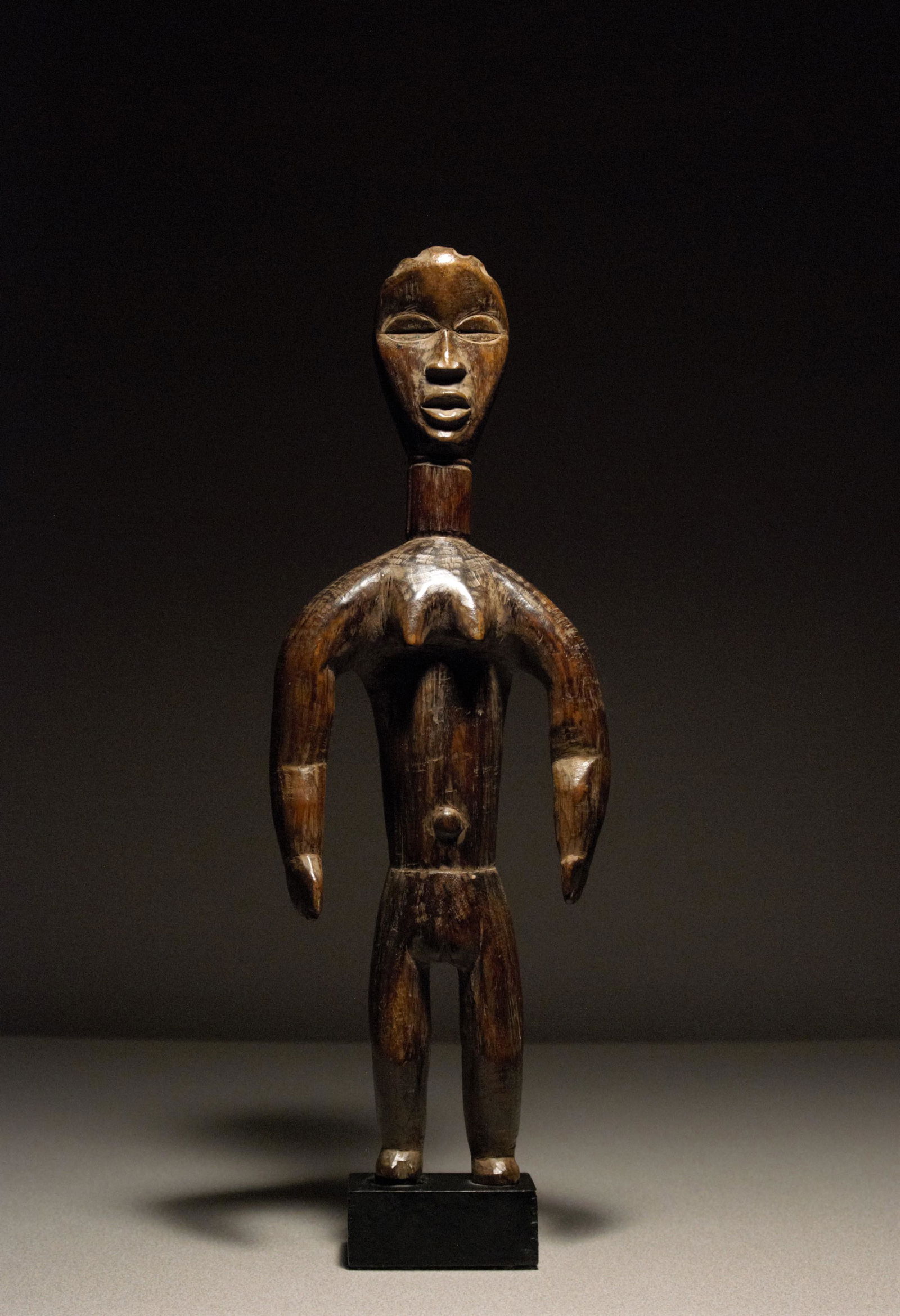 Dan Ppls Favorite female spouse figure: Favorite female spouse figure Dan peoples Liberia, West Africa Early 20th century Hardwood with darkened, varied, shiny, aged patina 15.25"H x 5.50"W In very fine condition with a small, old, minor lo