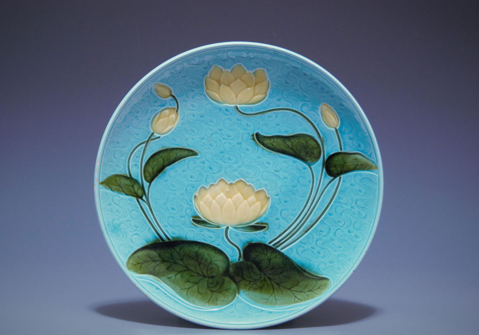 Majolica Plate w/ Water Lily Motif: Majolica plate with water lily motif Schramberg SMF Germany circa 1915 In very fine condition with a few minor losses to the glaze along the rim edges, 11.75" diam With beautiful, three-dimensional co