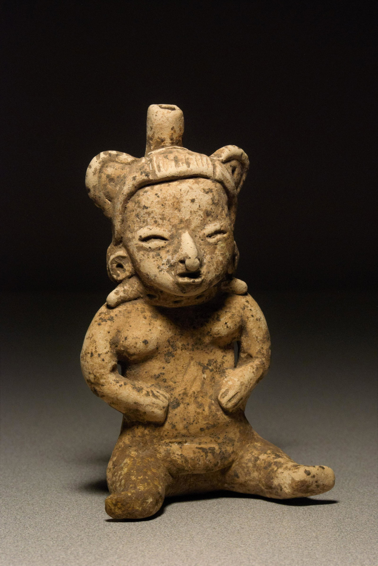 Preclassic Maya Seated Whistle Figure: Preclassic Maya seated whistle figure, Chalchuapa type, 500-200 BCE, Buff earthenware, solid and hollow sections, hand- modeled with applique, incising and punctate technique. 6.50"H. Mint condition w