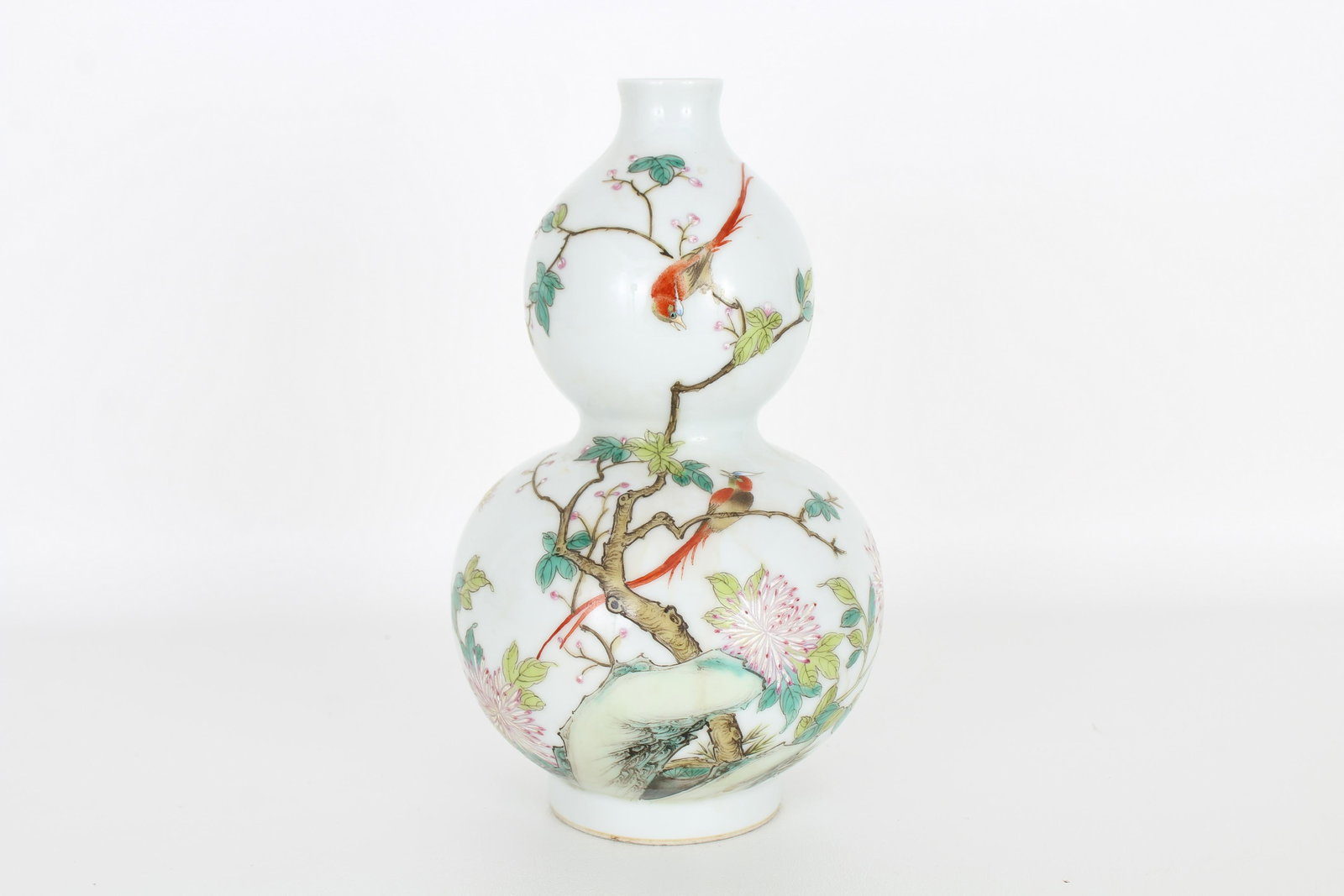 Chinese famille rose double-gourd-shaped vase: Chinese famille rose double-gourd-shaped vase, qianlong mark. Provenance: Private Montreal, Canada estate. Dimensions: 8.5 x 5 in.