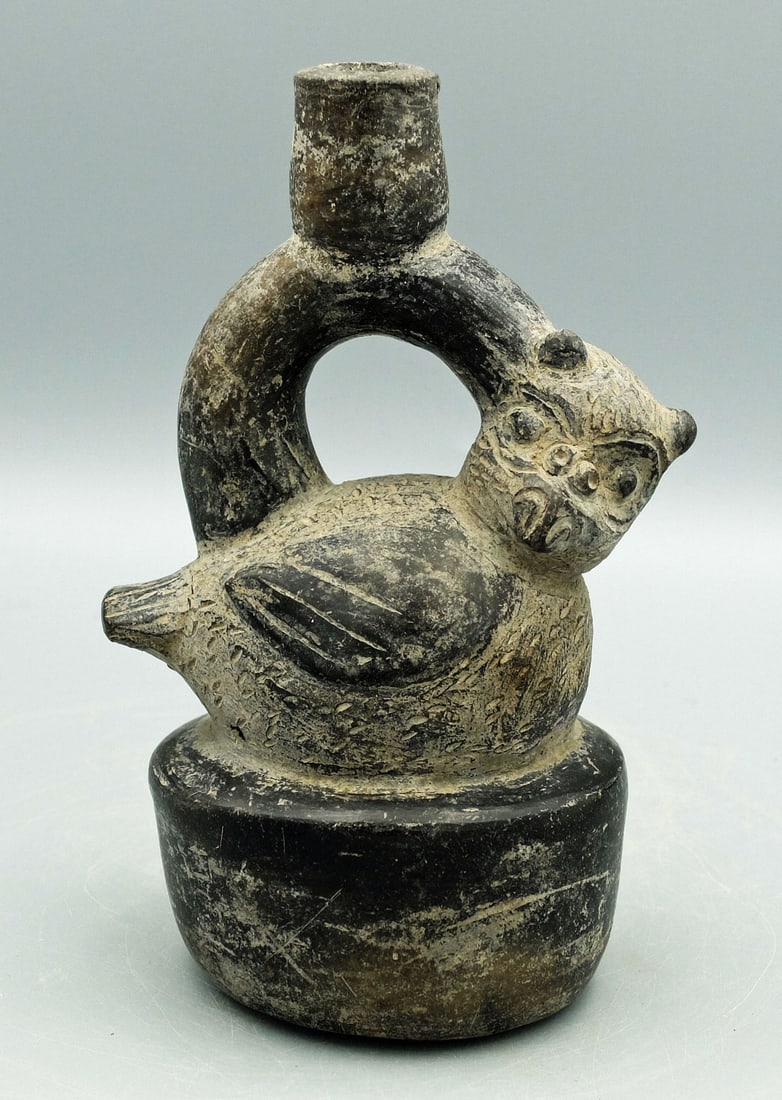 Cupisnique Avian Bottle - Peru: A fine Cupisnique avian bottle from Peru, ca. 800 - 200 BC. This nicely detailed stirrup vessel is 7 in. high and features a nesting owl. The facial features are nicely detailed and feathers are indic