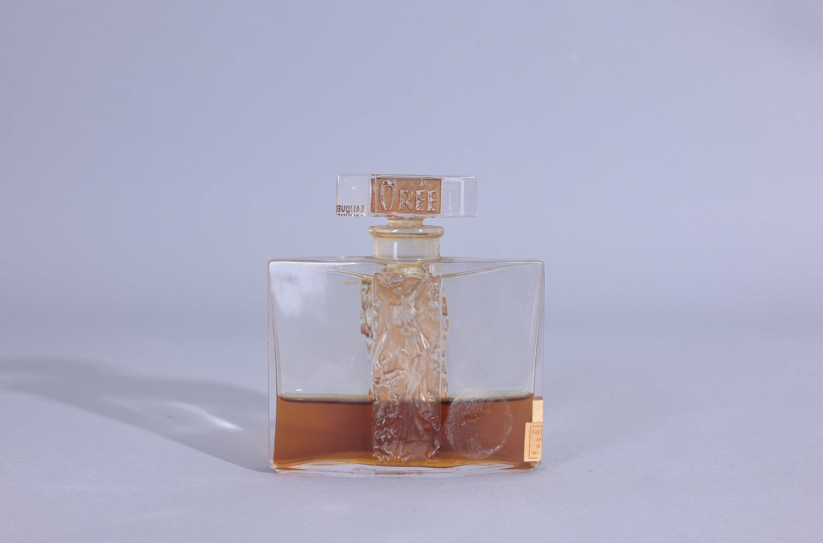 Rene Lalique 'Danae' Perfume Bottle: Rene Lalique 'Danae' Perfume Bottle for Magasin du Louvre, Paris, circa 1930, in clear and frosted glass with sepia patina. Molded LALIQUE. (Lalique - 28) Provenance: single owner lifetime collection 