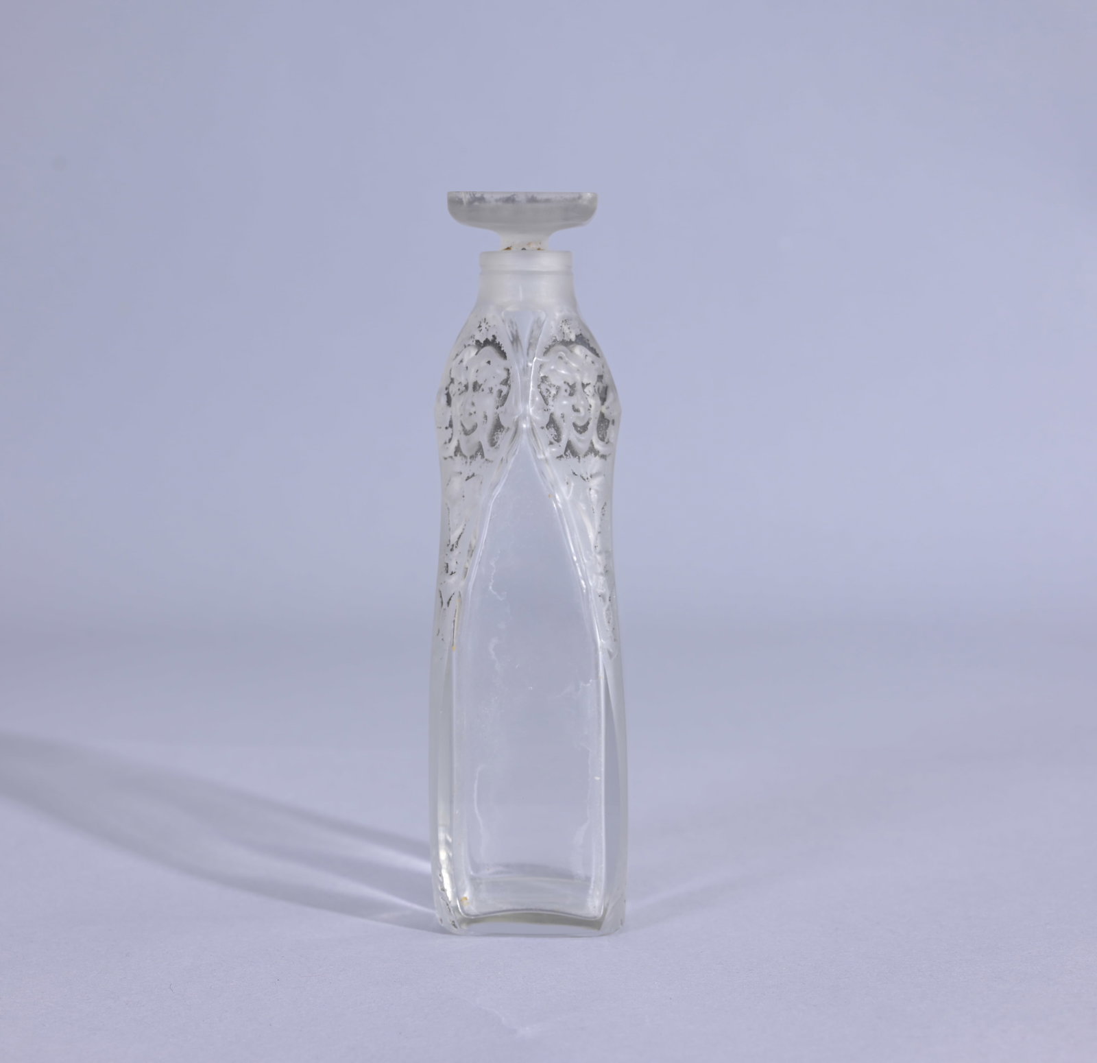 R Lalique Satyrs Glass Perfume Bottle: R. Laique - Flacon - Small Glass bottle with Satyrs faces and fig leaves (Lalique - 25) Provenance: single owner lifetime collection from Jacksonville, FL - Entire collection has been donated to St. E