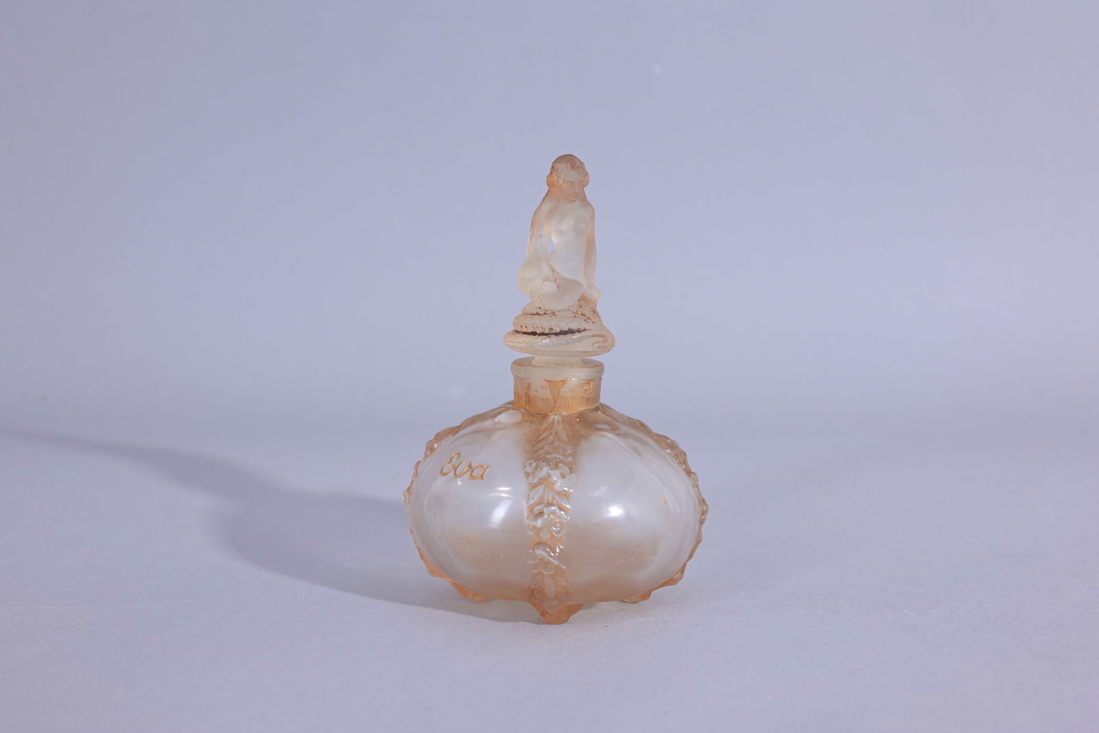 Julien Viard 'Eva Lubin' Perfume Bottle: Julien Viard 'Eva Lubin' Perfume Bottle figural perfume bottle and stopper, clear/frost glass, sepia patina. Circa 1920 Stopper stuck. Condition: appears to have repairs to broken neck of bottle (Juli
