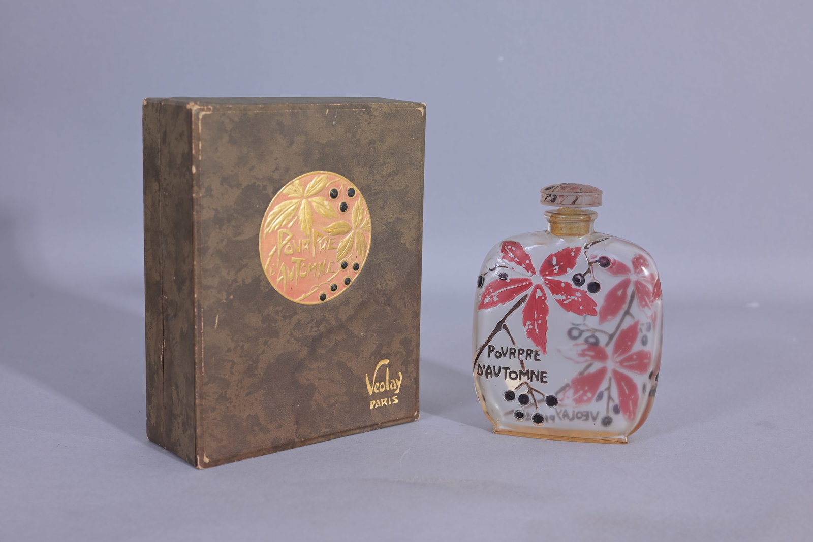 Lucien Gaillard Perfume Bottle for Veolay Pourpre: 1924 Lucien Gaillard for Veolay Pourpre d'Automne clear glass perfume bottle and frost stopper, front and back low relief detail and labeling, box with embossed Art Nouveau labeling. (Misc - 69) Prove