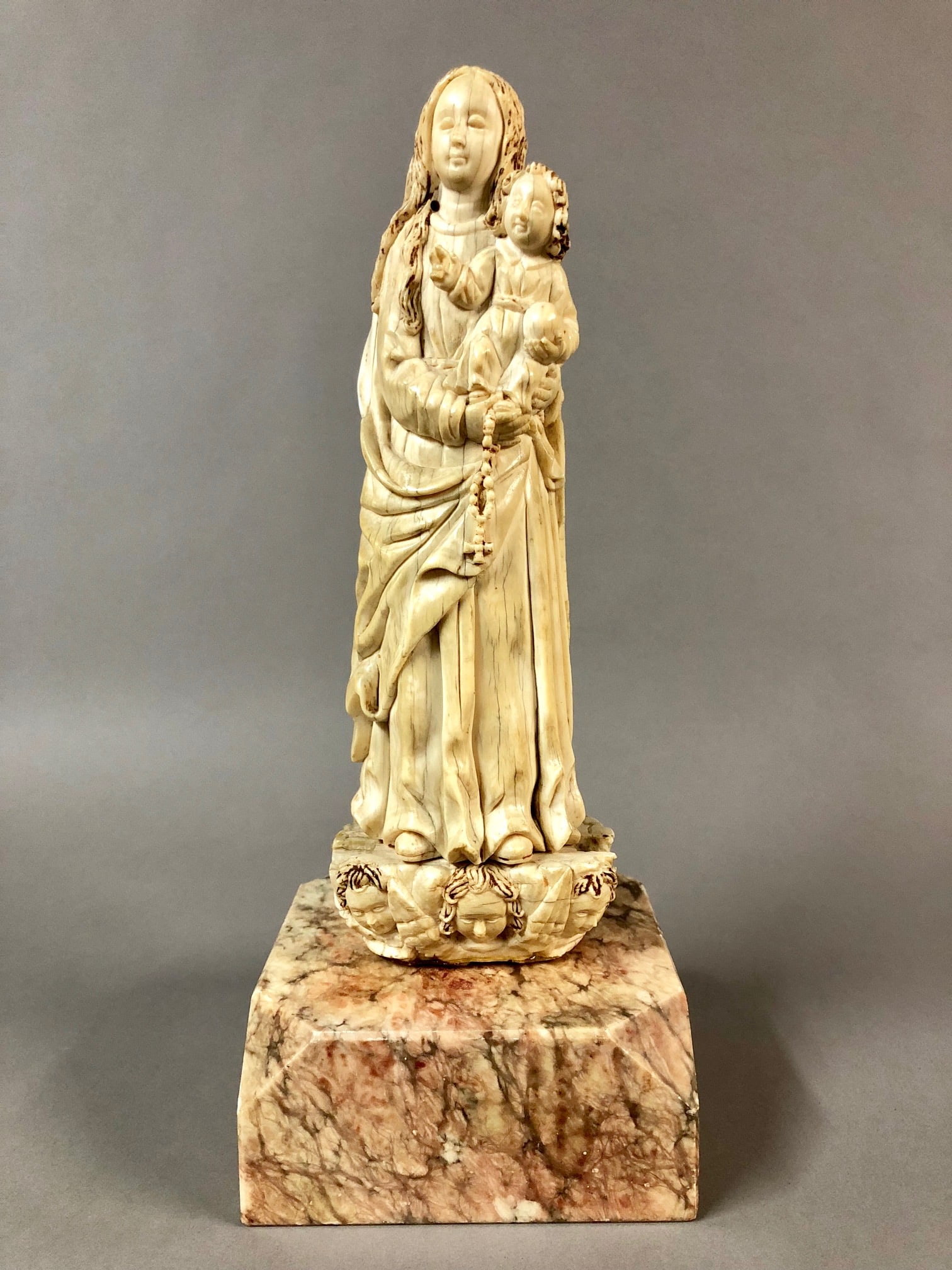17th - 18th Century Sino-Portuguese Ivory Group: Rare 17th - 18th Century Sino-Portuguese Ivory Group of the Madonna and Child of typical iconography. Portraying the Virgin Mary with long hair and flowing robes, holding the child Jesus with both han