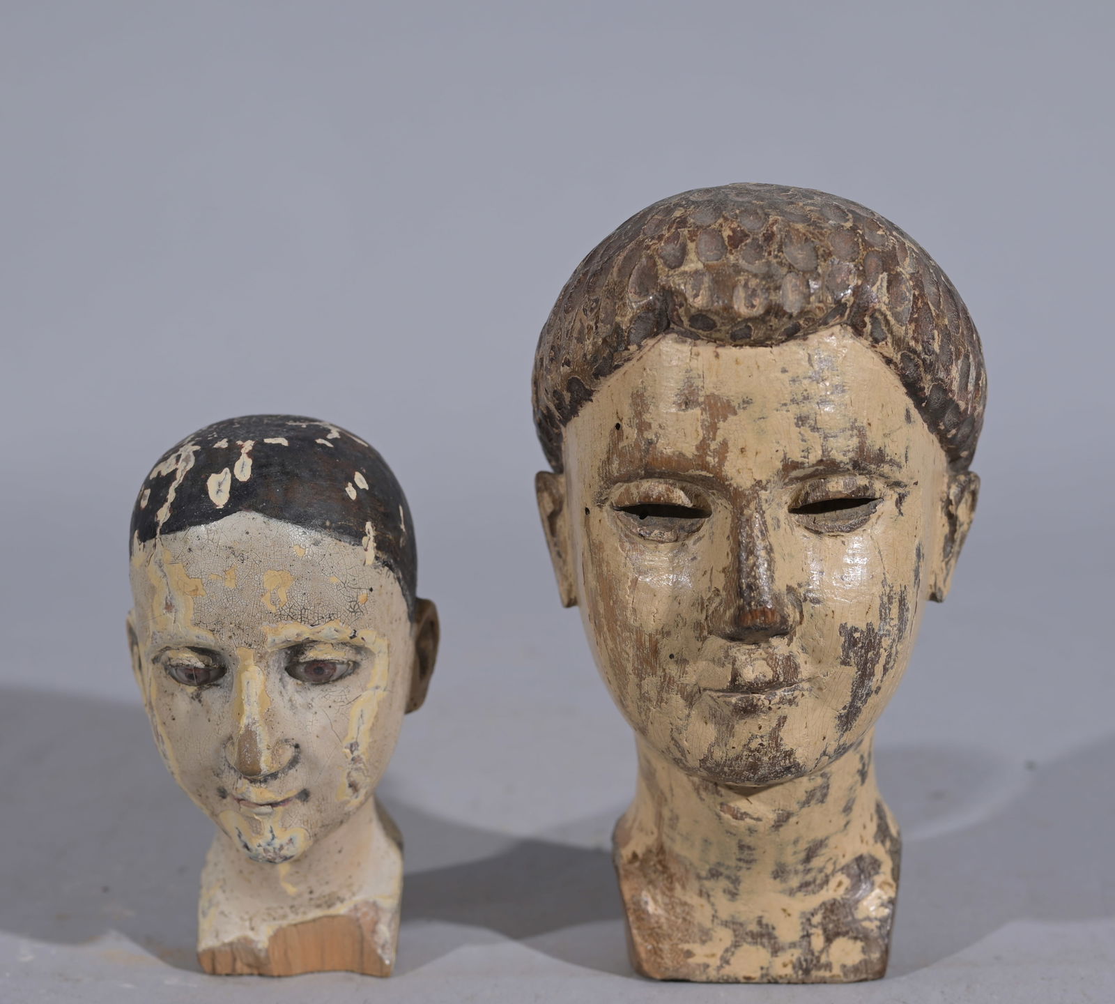 (2) Antique Carved Polychrome Santos Heads: Heights: 4.25 / 6 in. - Provenance: this item comes from the private collection of Lou A. and Barbara B. Pritchett. Lou Pritchett was the ex-Vice President of Procter and Gamble. Lou Pritchett rose th