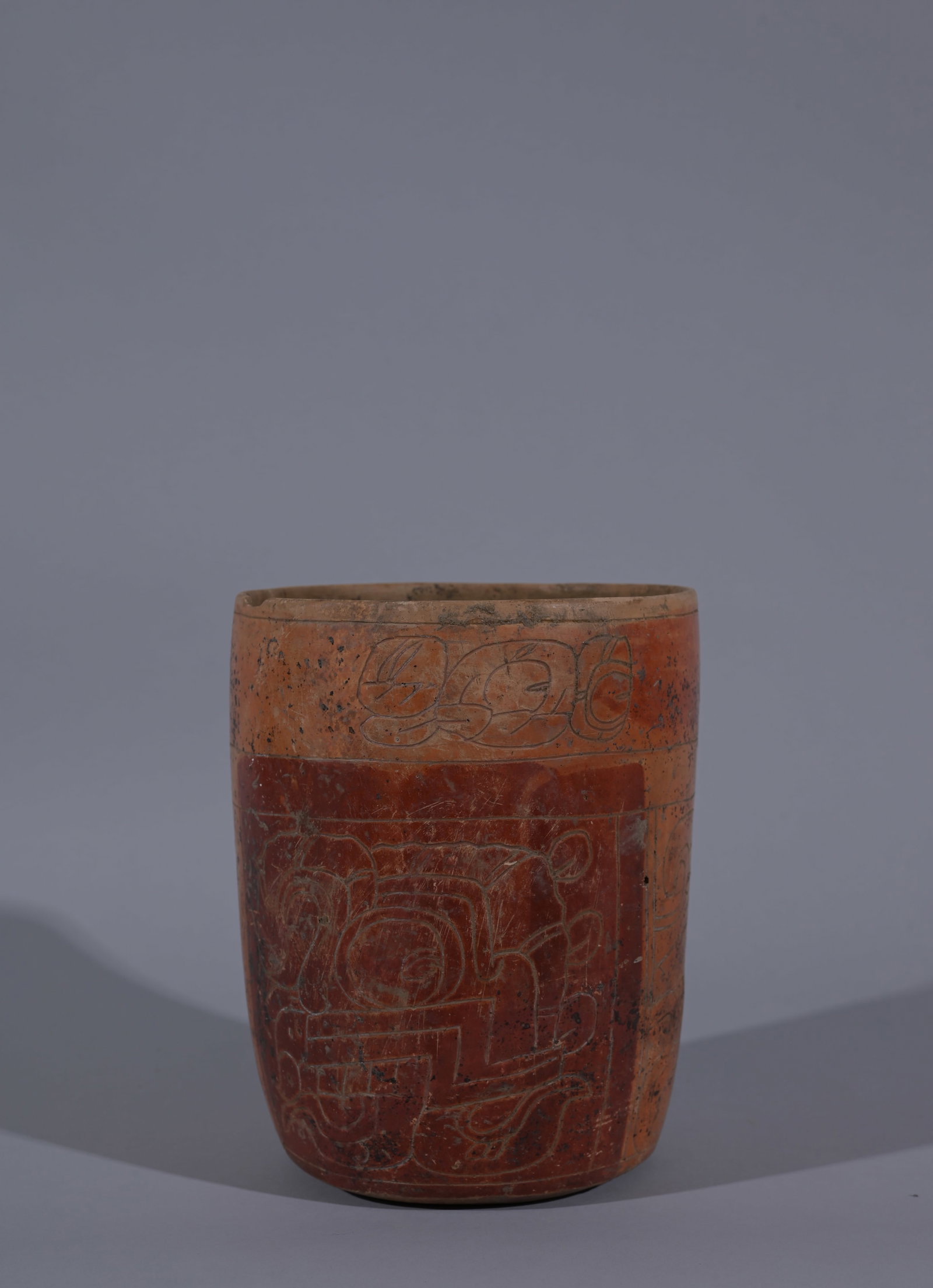Maya Cylinder from Guatemala: A marvelous Maya cylinder from Guatemala, ca. 400 ? 700 AD. This thin-walled beauty featured two incised renditions of Chaac the rain God, highlighted in blood red. These primary panels are separated