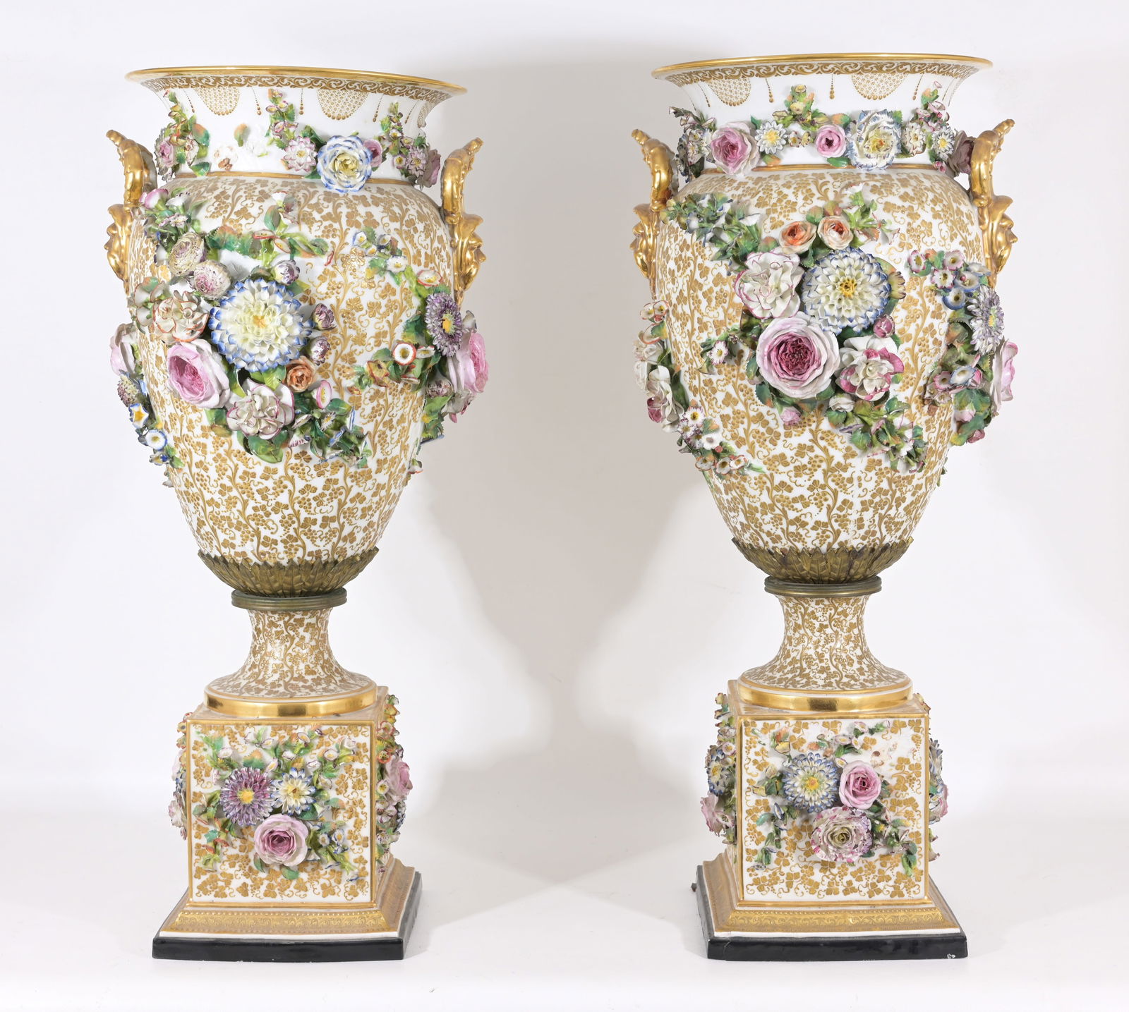Pair of Jacob Petit (1796 - 1865) Porcelain Vases: Pair of large ornate vases by Jacob Petit of Paris, c. 1840. Urn shape w/ gold design on bodies, scaled flowers and applied gold handles. Cubed bases and applied flowers on body and bases. Some chippi