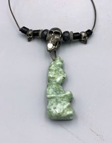 unusual folk-art necklace featuring a pewter skull