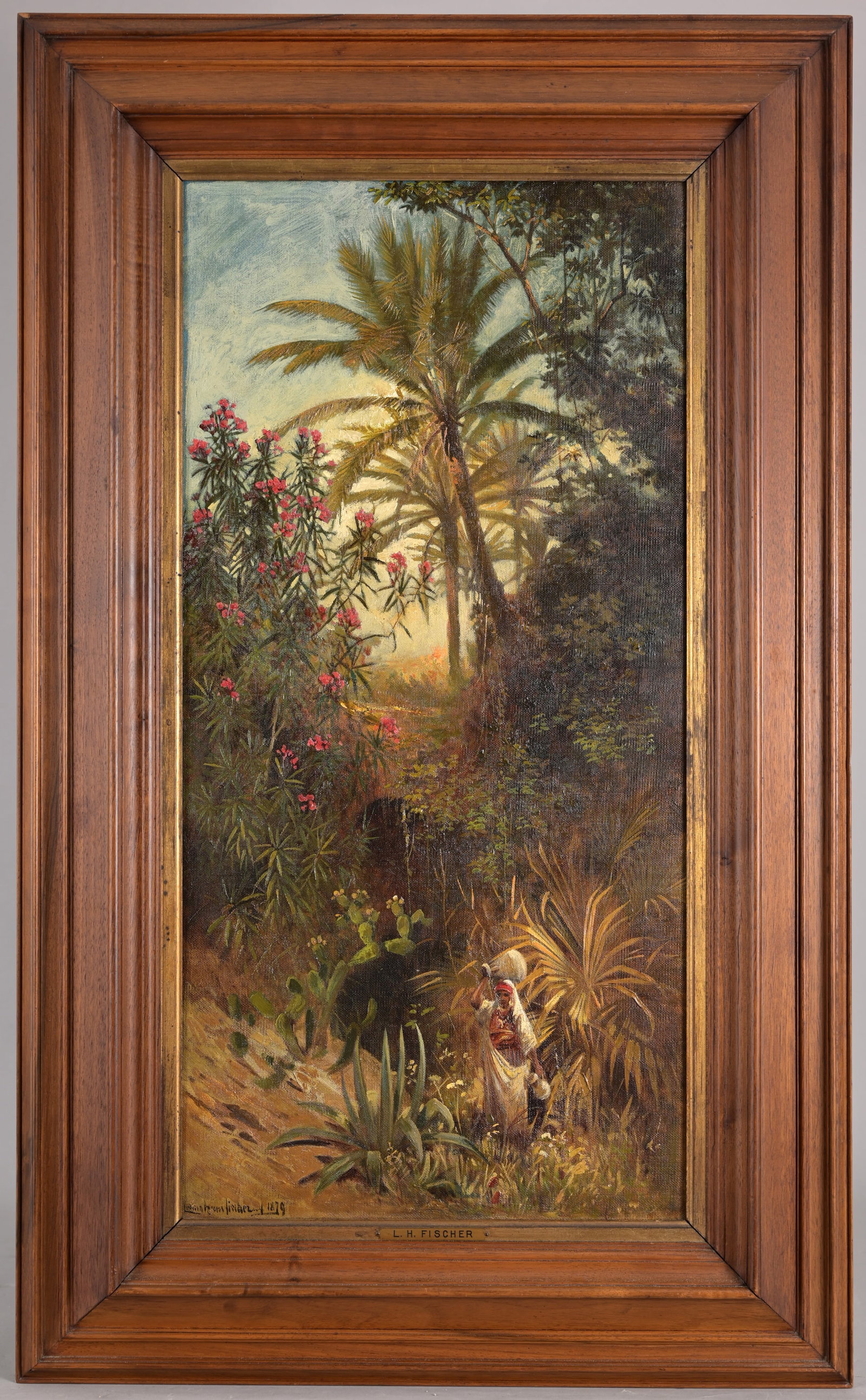 Ludwig Hans Fischer (German, 1848 - 1915): Ludwig Hans Fischer (German, 1848 - 1915) Orientalist painting of a woman carrying water vessels through a lush landscape. Oil on Canvas. Signed and dated (1879) lower left. Sight Size: 26.5 x 13.5 in