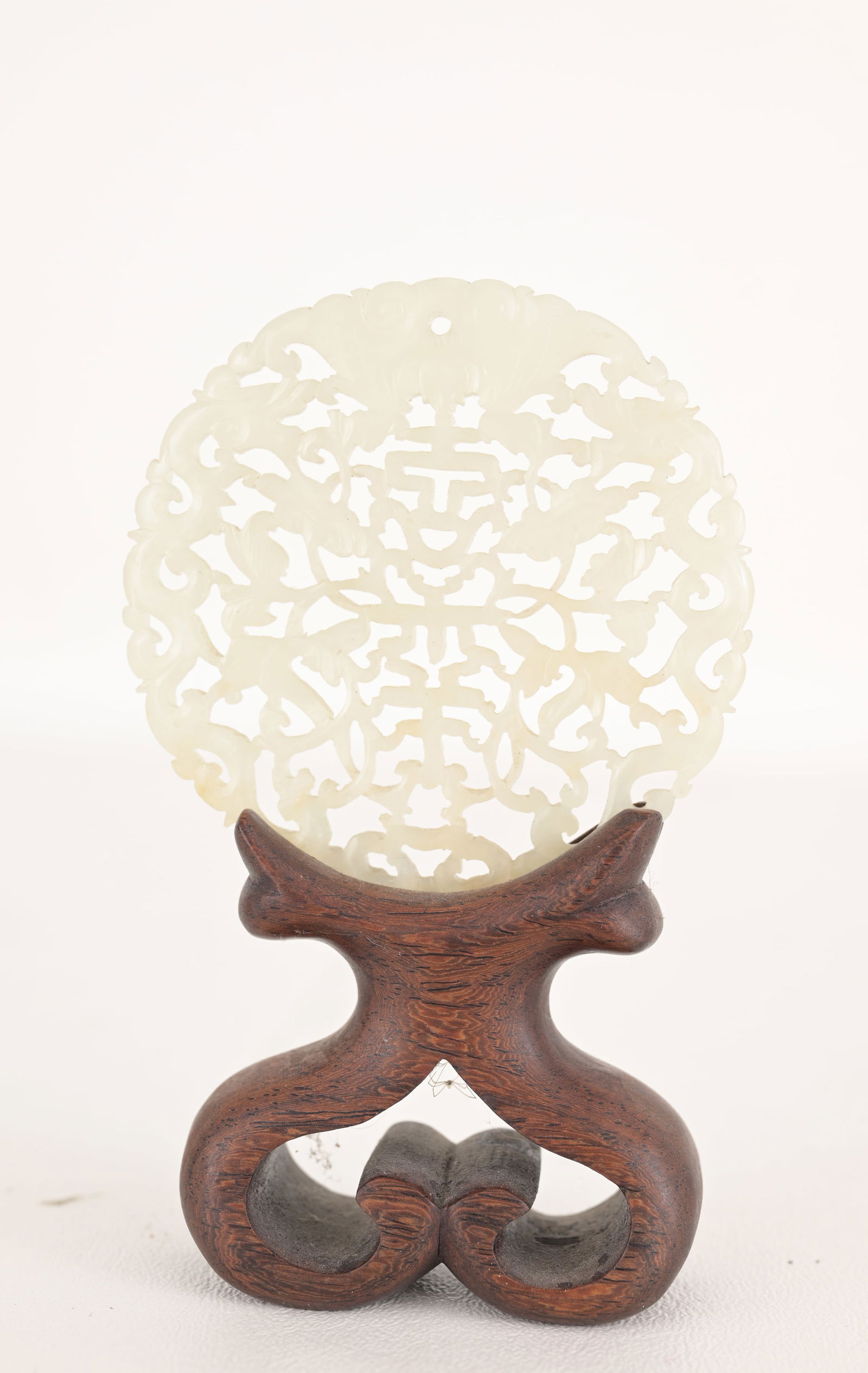 Chinese Carved/Reticulated Jade Pendant on Stand: Chinese Carved/Reticulated Jade Pendant on Stand. Diameter of Pendant: 2.75 in.