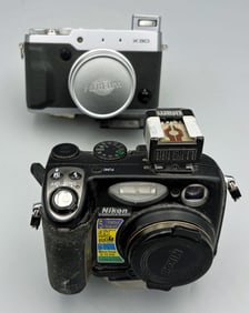 Two digital cameras with attachments
