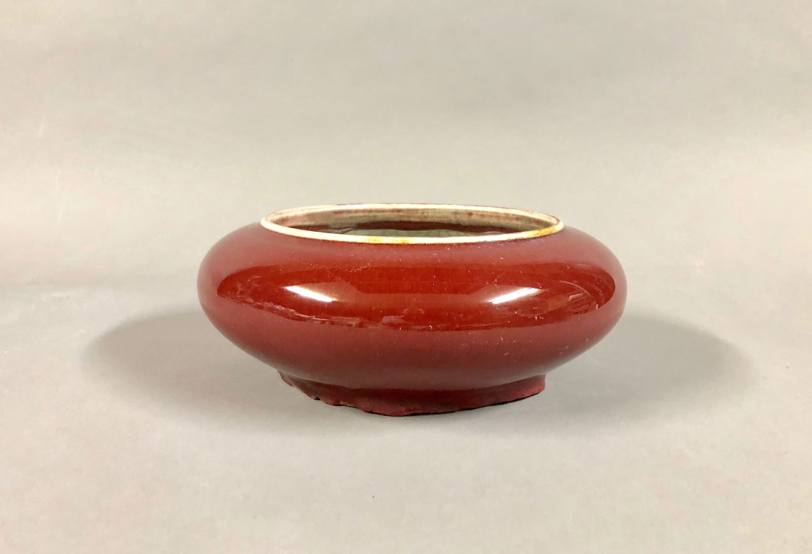 Chinese Red and Crackle Glazed Brush Washer: A Chinese Red and Crackle Glazed Brush Washer. The body glazed in red, and the interior and base glazed in white crackle glaze. Dimensions: 3 H x 8 D in.