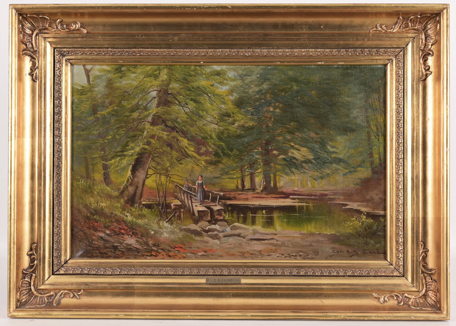 Carl Ove Julian Lund (1857 - 1936): Carl Ove Julian Lund (1857 - 1936) Wooded landscape scene with figures. Oil on canvas. Signed lower right. Inscribed verso. Sight Size: 12.5 x 19.5 in. Overall Framed Size: 18 x 25.5 in.