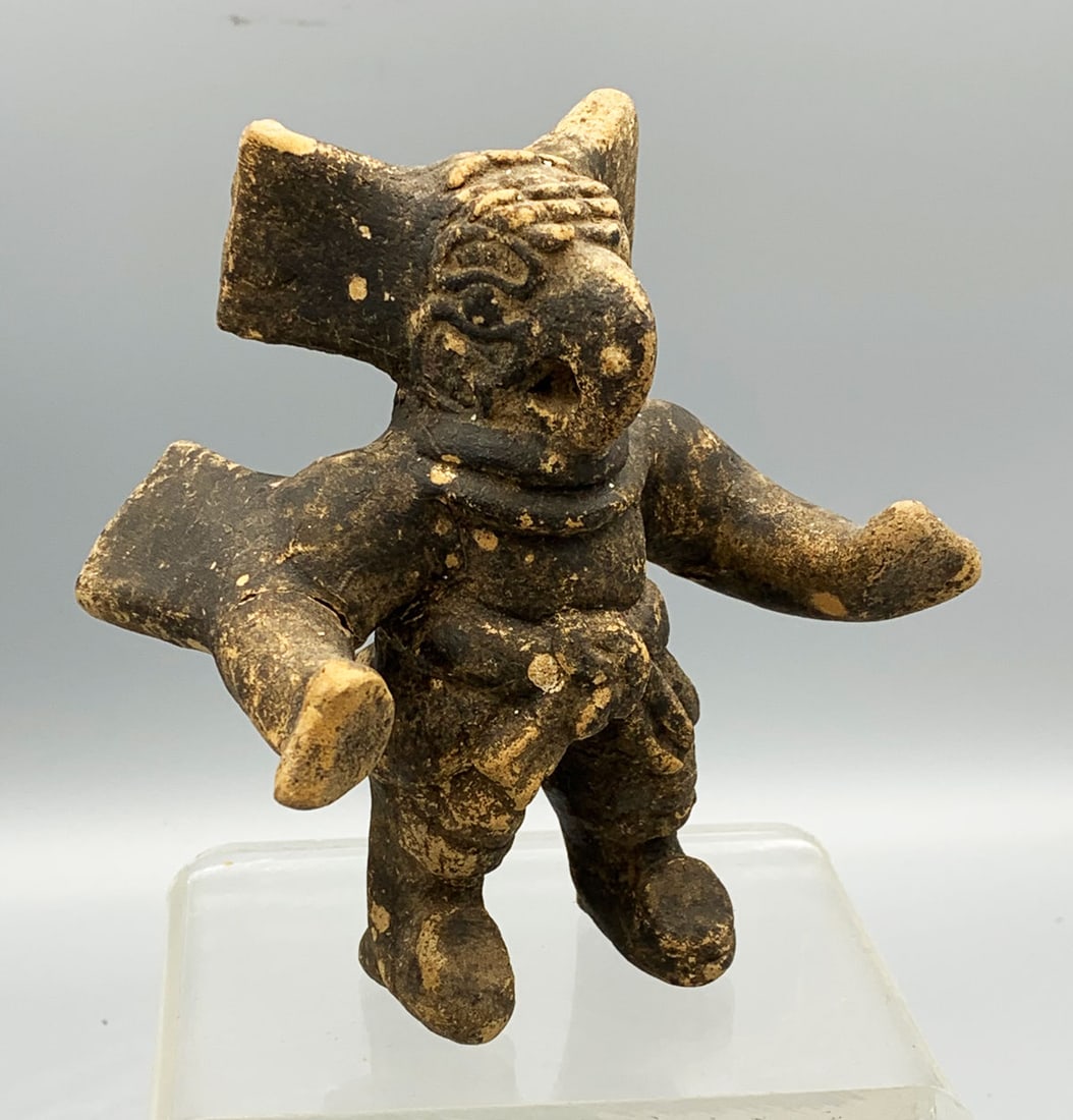 Maya Whistle Figurine - Guatemala: An exceptional Maya whistle figurine from Guatemala, ca. 200 - 600 AD. It is 4-3/4 in. tall and depicts a costumed dancer. He is adorned with a superbly detailed avian helmet that shows masterful open