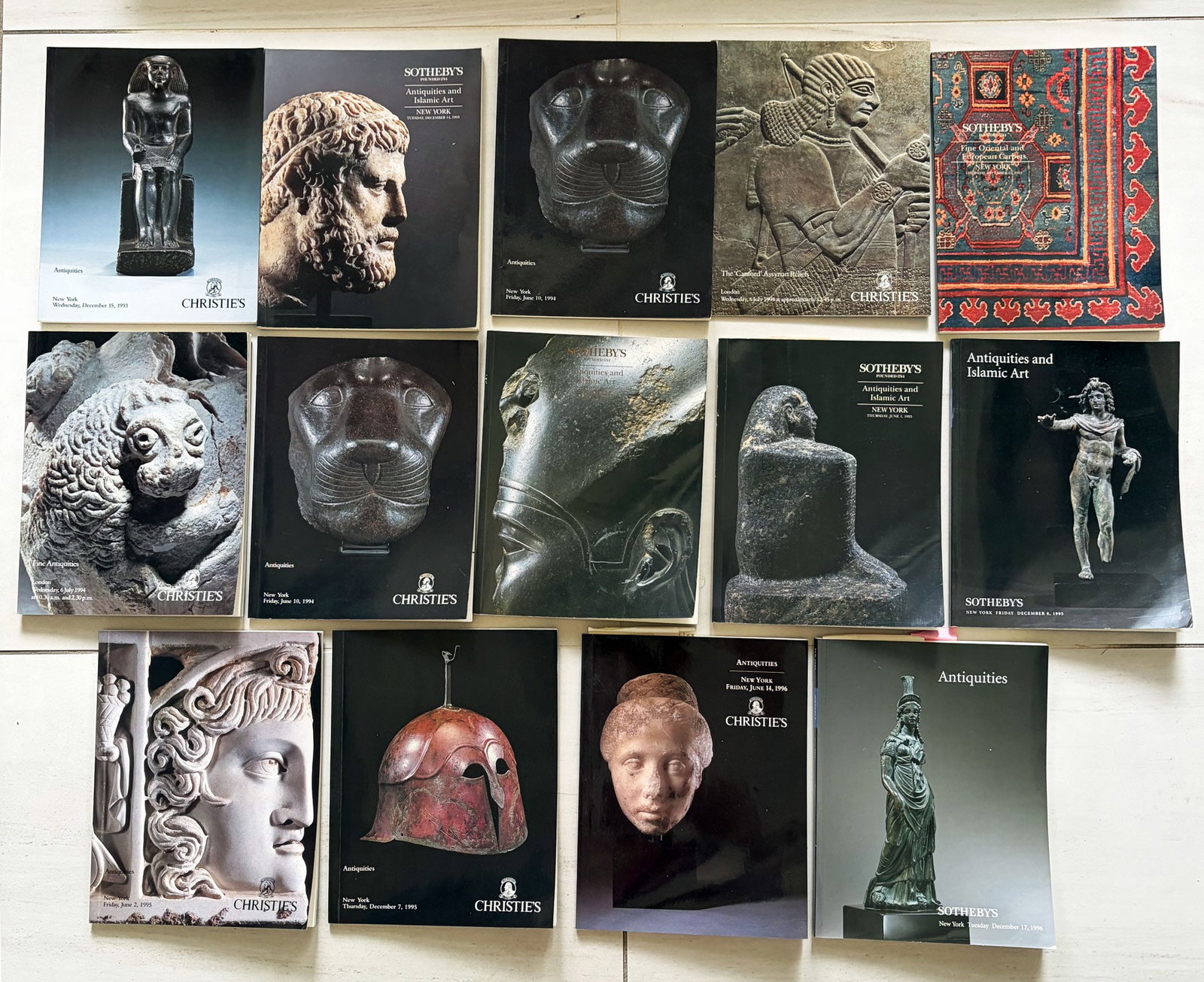 group of 14 Sotheby's and Christie's catalogs: A group of 14 Sotheby's and Christie's catalogs, 1993 - 1995, New York and London. They feature Antiquities, Egyptian and Islamic art, many come with the prices realized lists. All are in excellent co