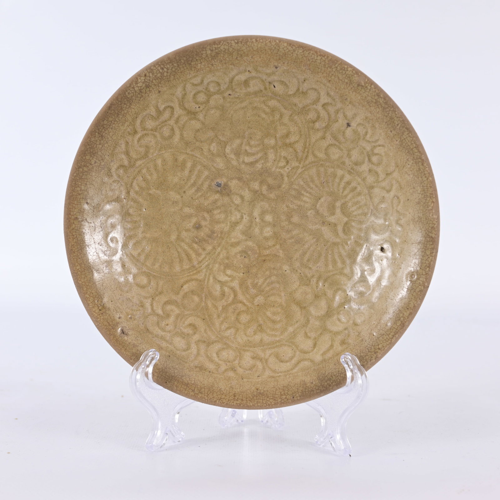 Antique Chinese Yaozhou Celadon-Glazed Dish: Early Antique Chinese Yaozhou Celadon-Glazed Dish. The shallow circular dish with gently rounded sides rising to a plain rim, the interior crisply molded with a dense design of stylized floral