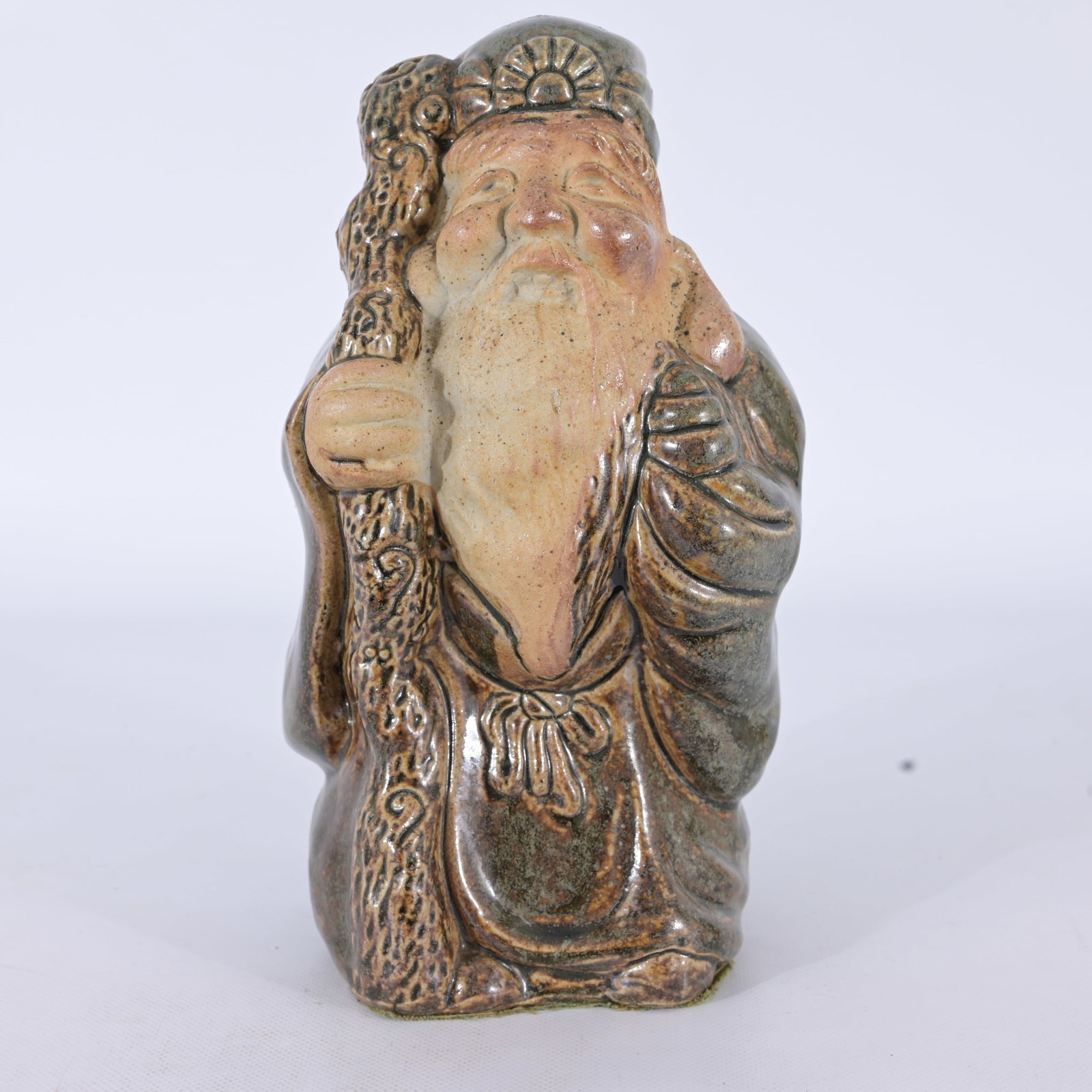 Japanese Ceramic Figurine depicting Jurojin: Japanese Ceramic Figurine depicting Jurojin, one of the famous Seven Lucky Gods of Japan (Shichifukujin). He represents longevity, wisdom, and a long life. Dimensions: 10 x 5.5 x 4.5 in.
