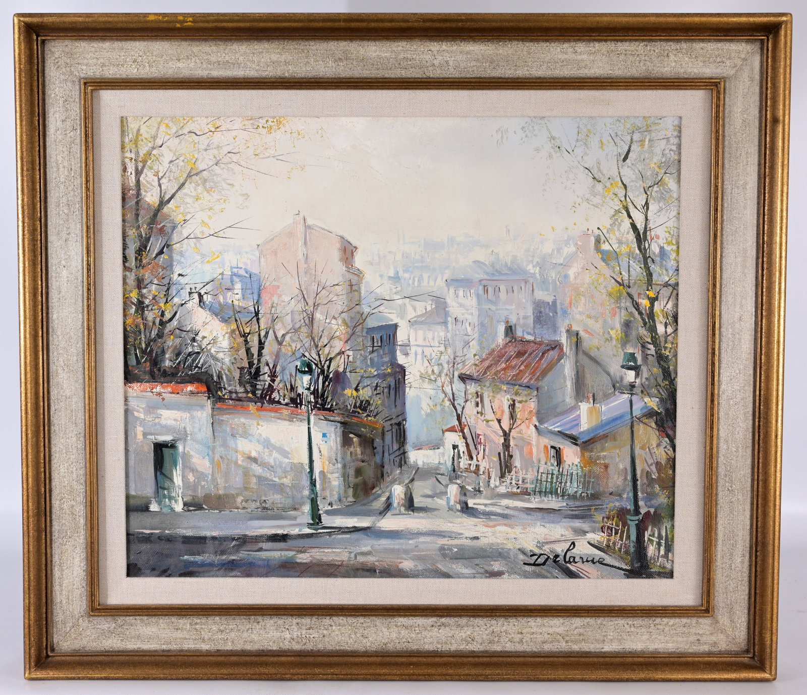 Lucien Delarue (France, 1925 - 2011): Lucien Delarue (France, 1925 - 2011) "Rue des Santes a Montmartre" Oil on Canvas. Signed lower right. Inscribed verso on canvas. Having multiple labels verso. Sight Size: 17.5 x 21 in. Overall Framed