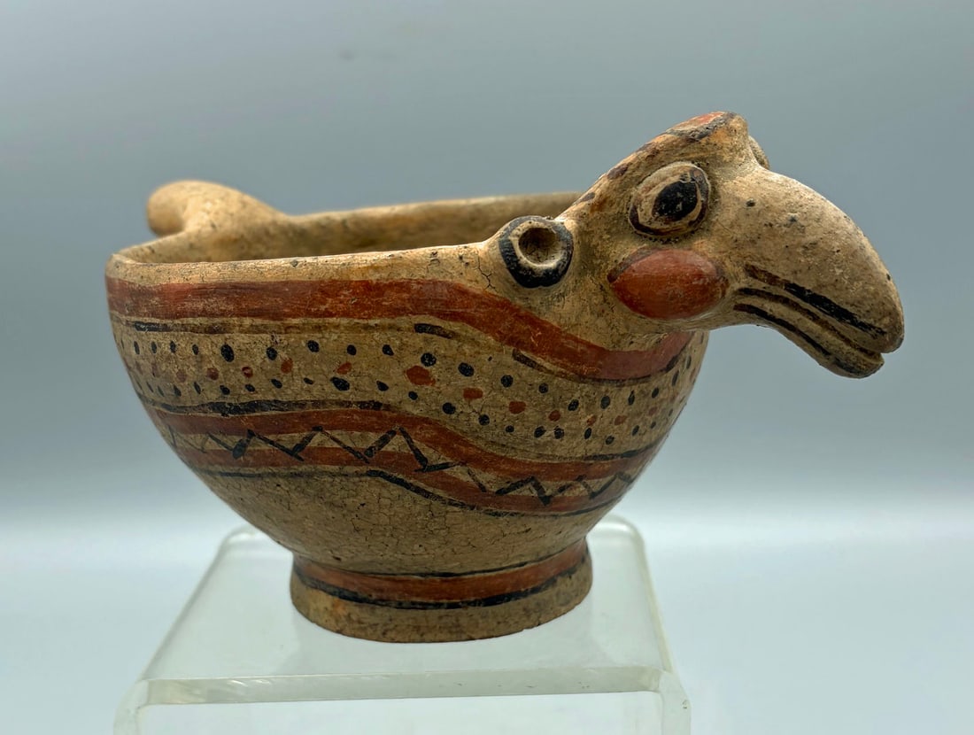 Nicoya avian vessel from Costa Rica: An exceptional Nicoya avian vessel from Costa Rica, ca. 800 - 1200 AD. This superb Mora Polychrome type is 7-1/2 in. long and depicts a parrot with bulging cheeks creating a humorous facial expression